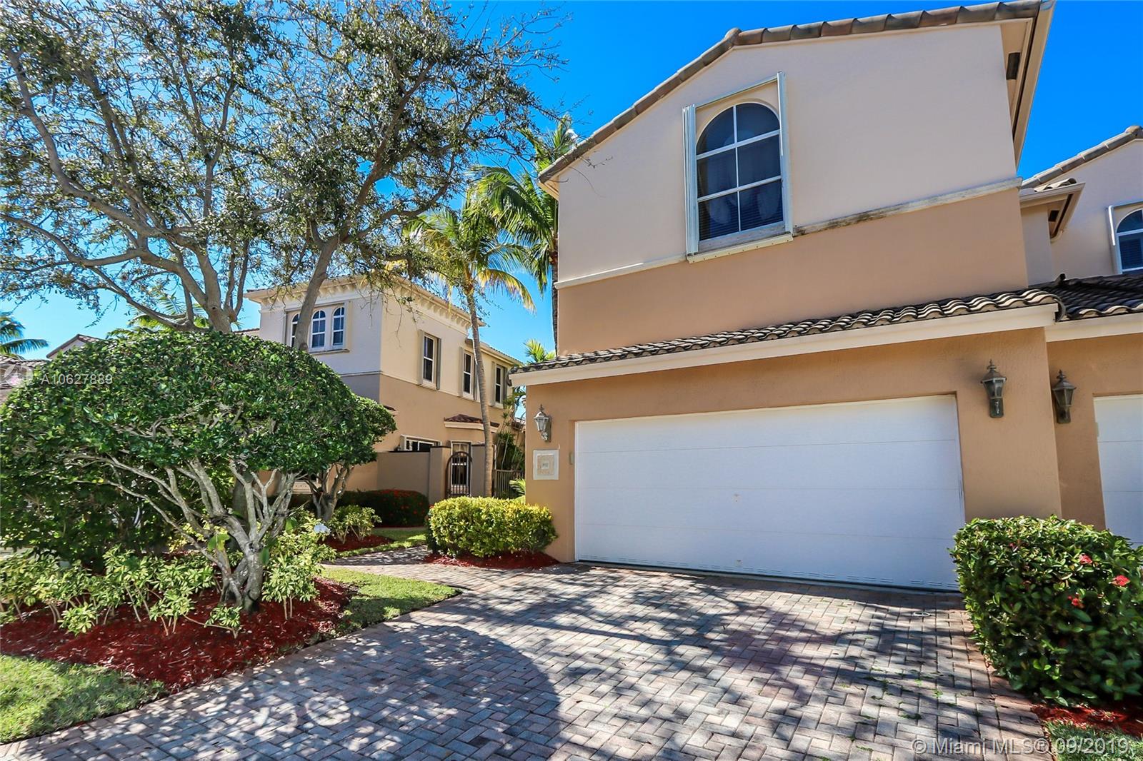 Front of the house facing North, double car garage with extra parking spaces on the pavers.