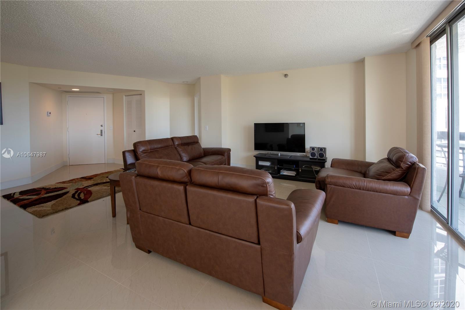 Photo of 3400 192nd St #704, Aventura, Florida, 33180 - Views from the foyer into the living room. Exquisite brand new porcelain tile floors.