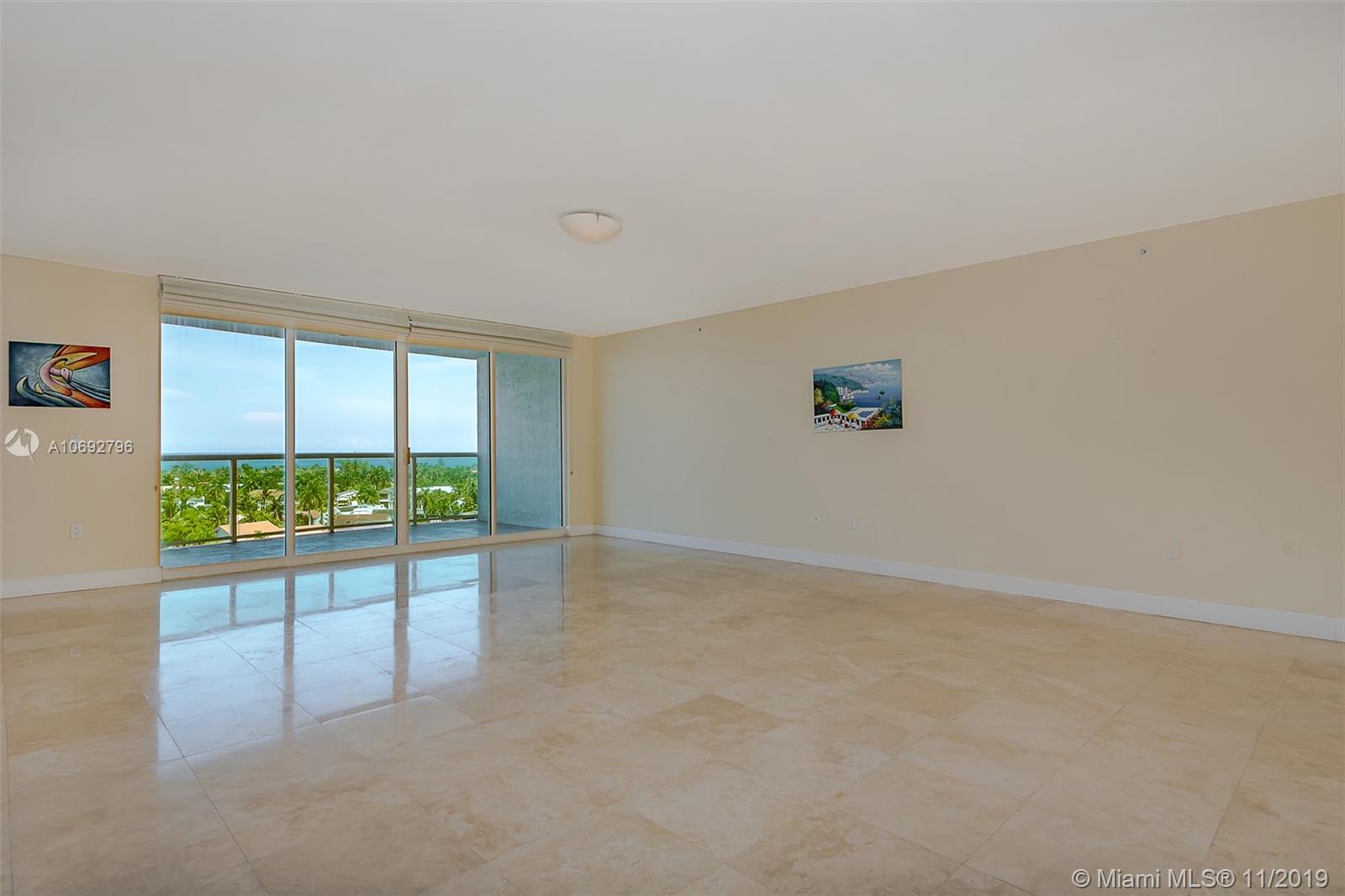Photo of 20201 Country Club Dr #903, Aventura, Florida, 33180 - Living room and dining room with direct water views.