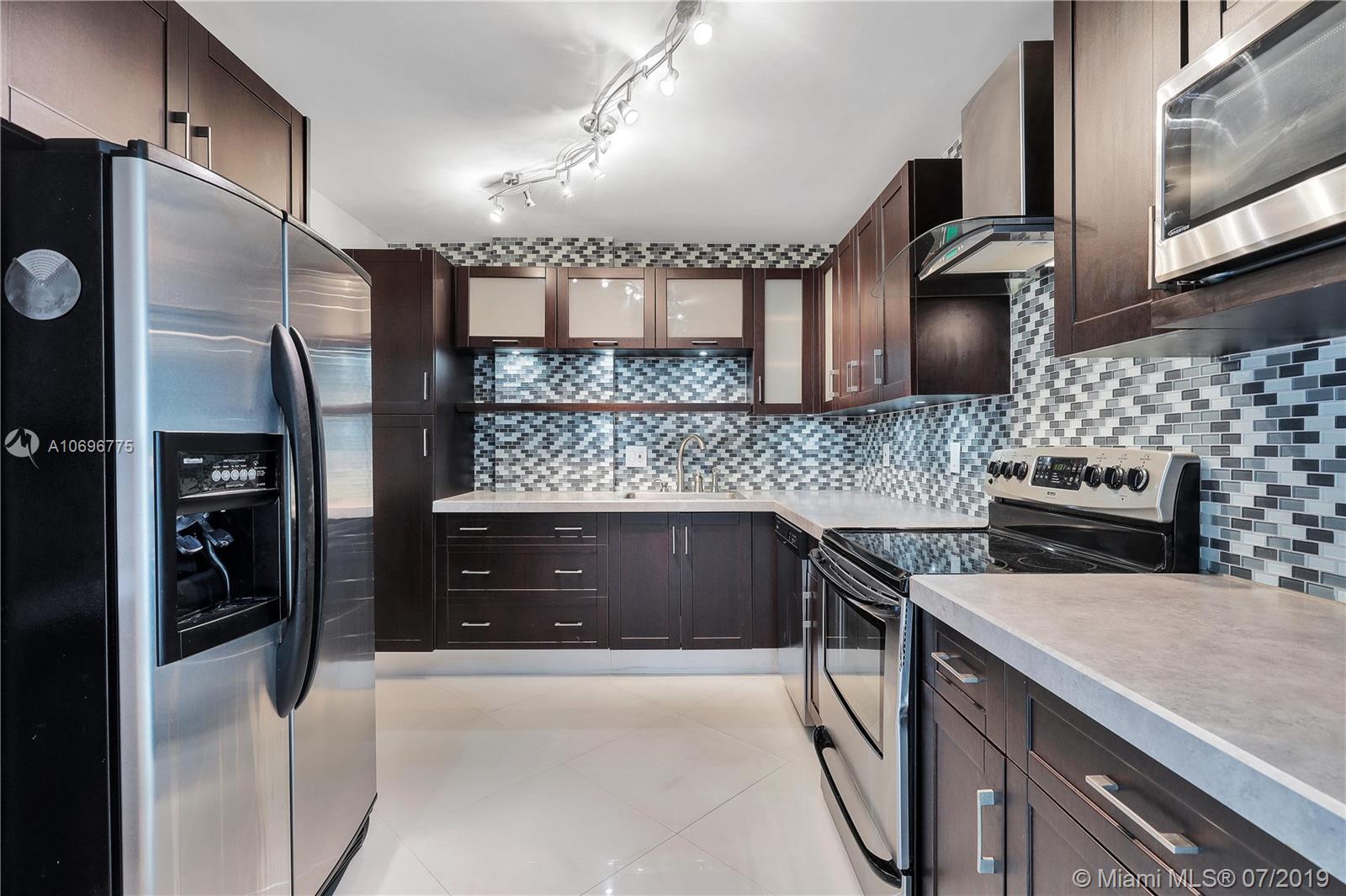Photo of 1500 Ocean Dr #11 J, Hollywood, Florida, 33019 - Stunning glass tile backspash, Stainless Steel applicances and tons of cabinets and drawers