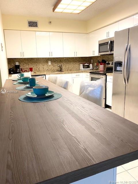 Photo of 3530 Mystic Pointe Dr #2607, Aventura, Florida, 33180 - brand new kitchen with counter and stools