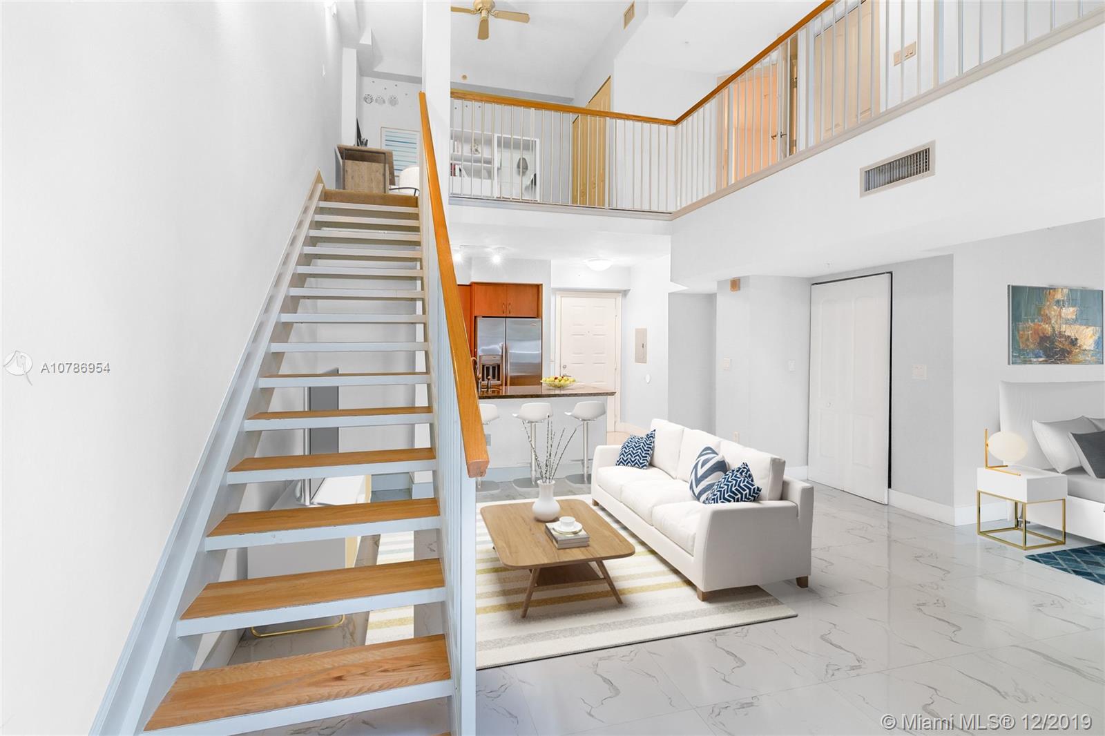 Living area and showing small office upstairs