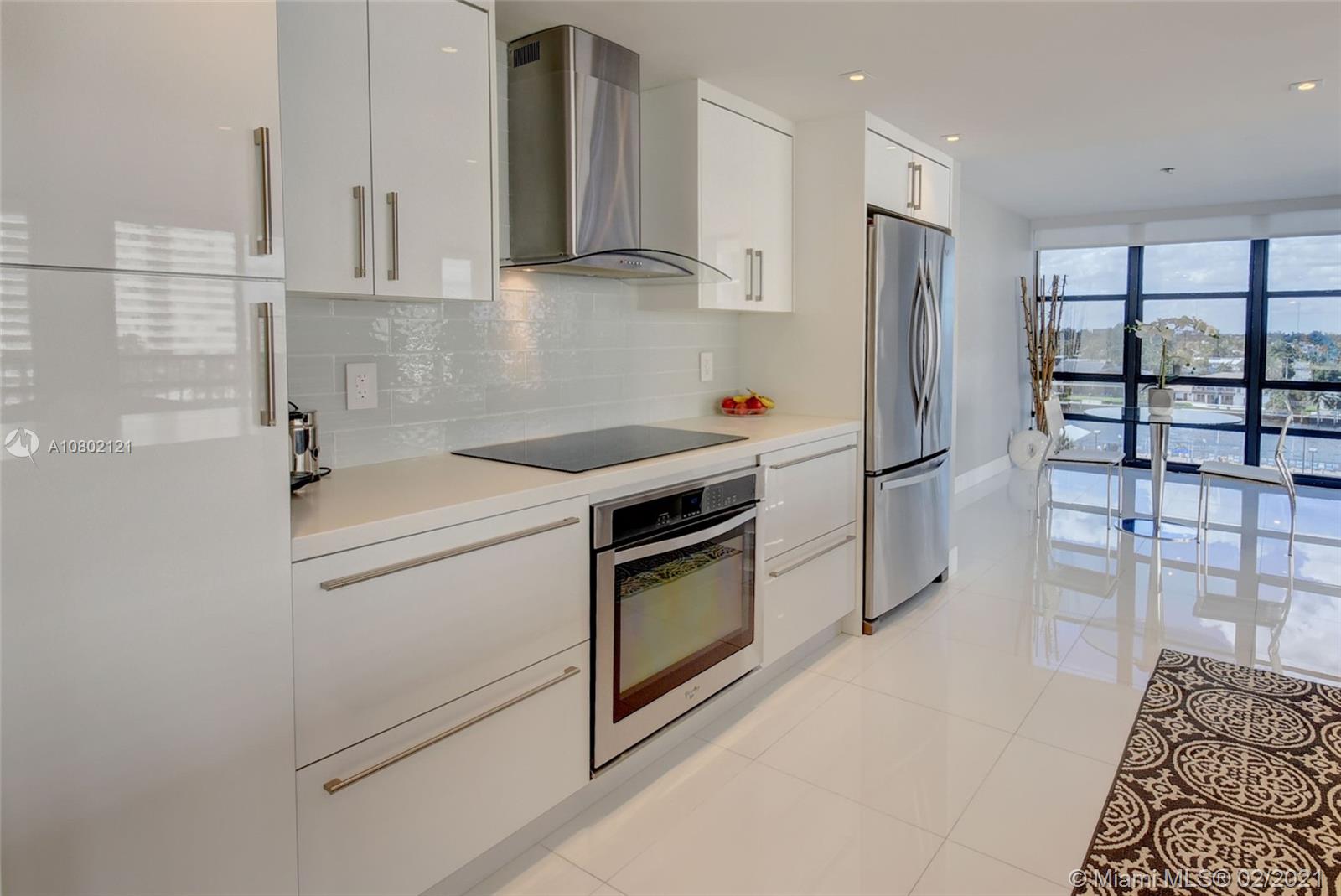 Photo of 2049 OCEAN DRIVE #702E, Hallandale Beach, Florida, 33009 - ultra modern open concept living room, dining room & kitchen featuring floor to ceiling windows with ocean and inter-coastal sunset views