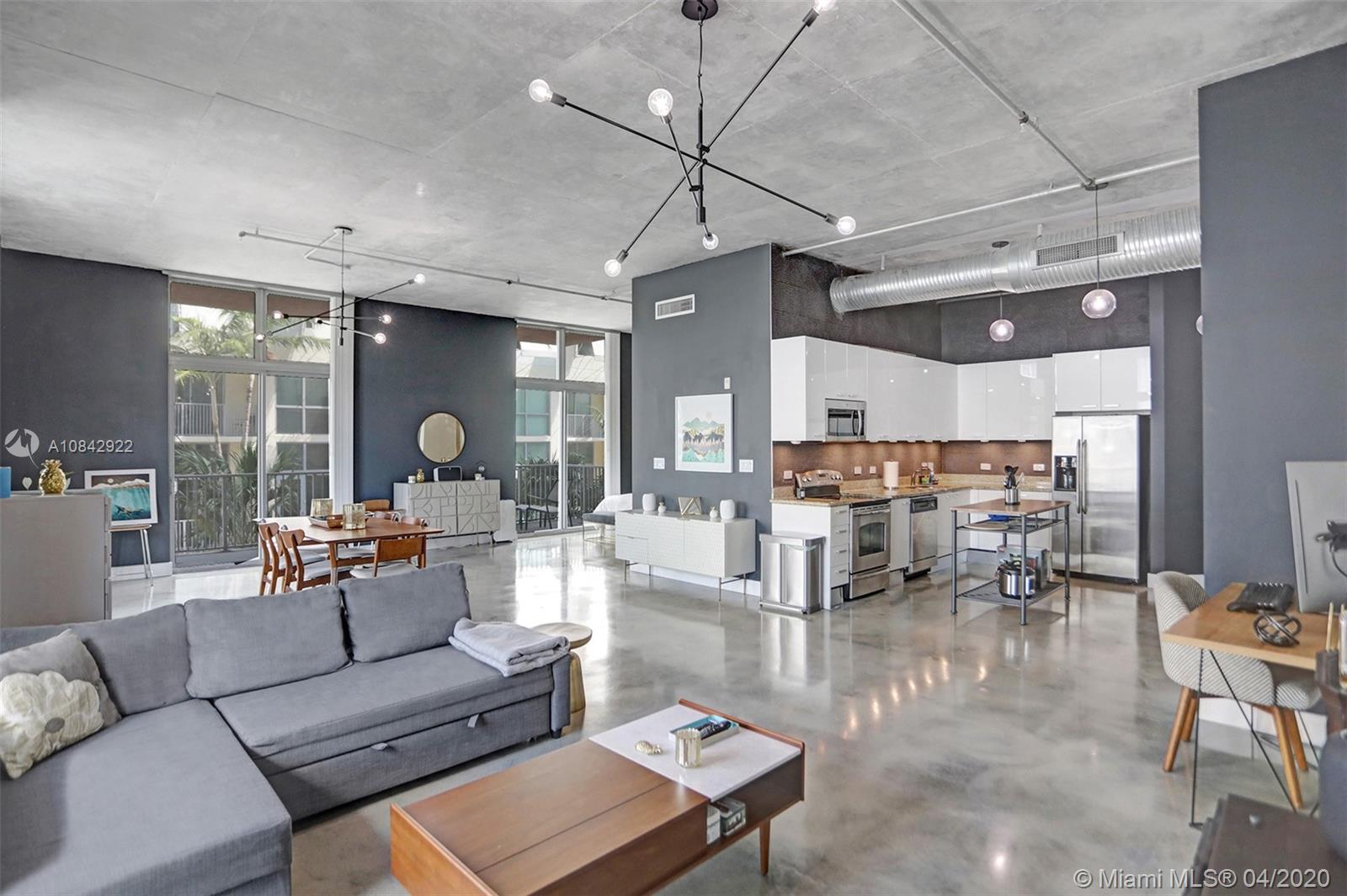 One-of-a-kind spacious corner unit loft, with large double balcony, located in the walkable downtown Hollywood.
