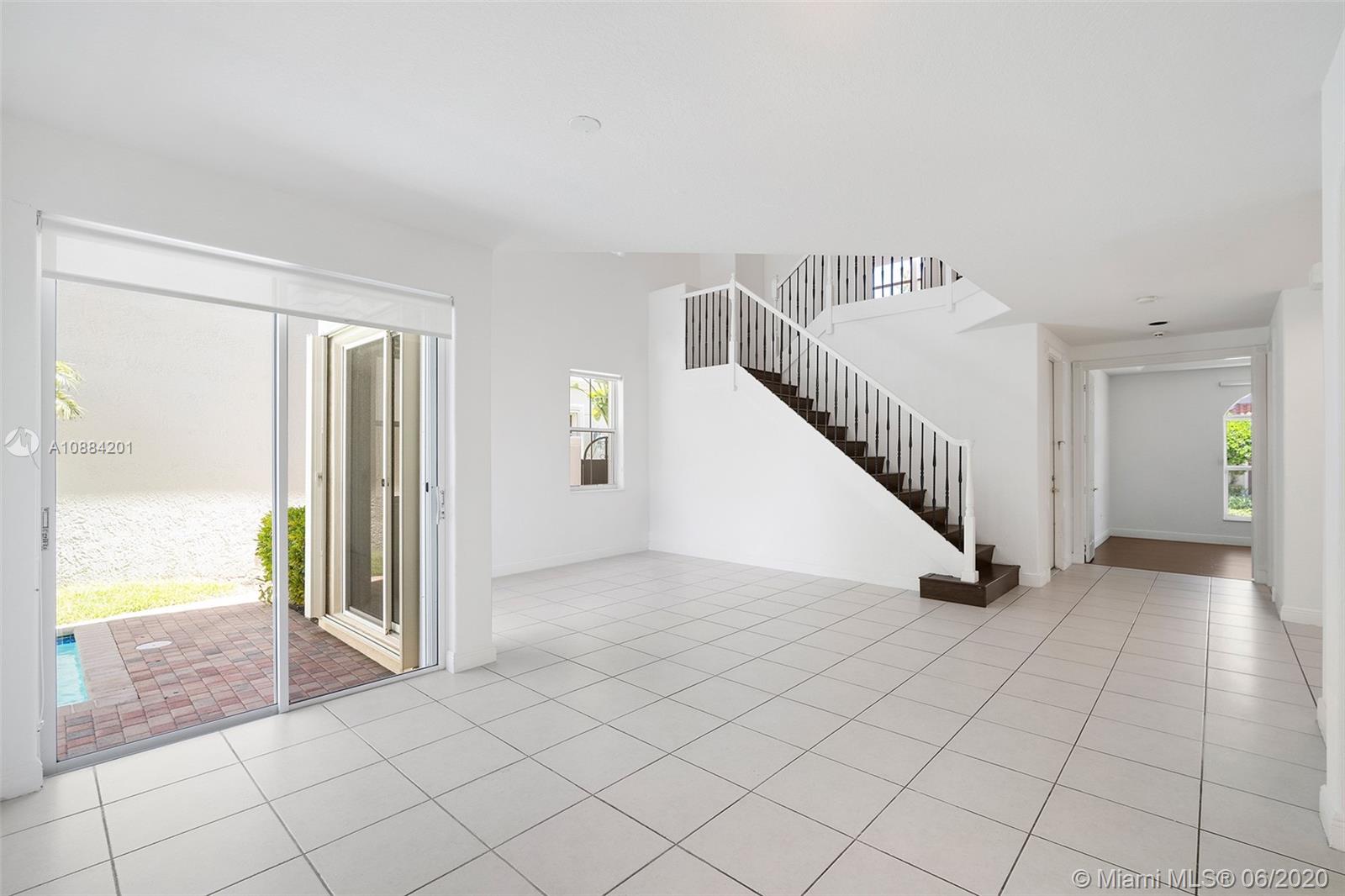 Photo of 1436 Breakwater Ter, Hollywood, Florida, 33019 - Entry door-Living room-Dining room / Stairwell