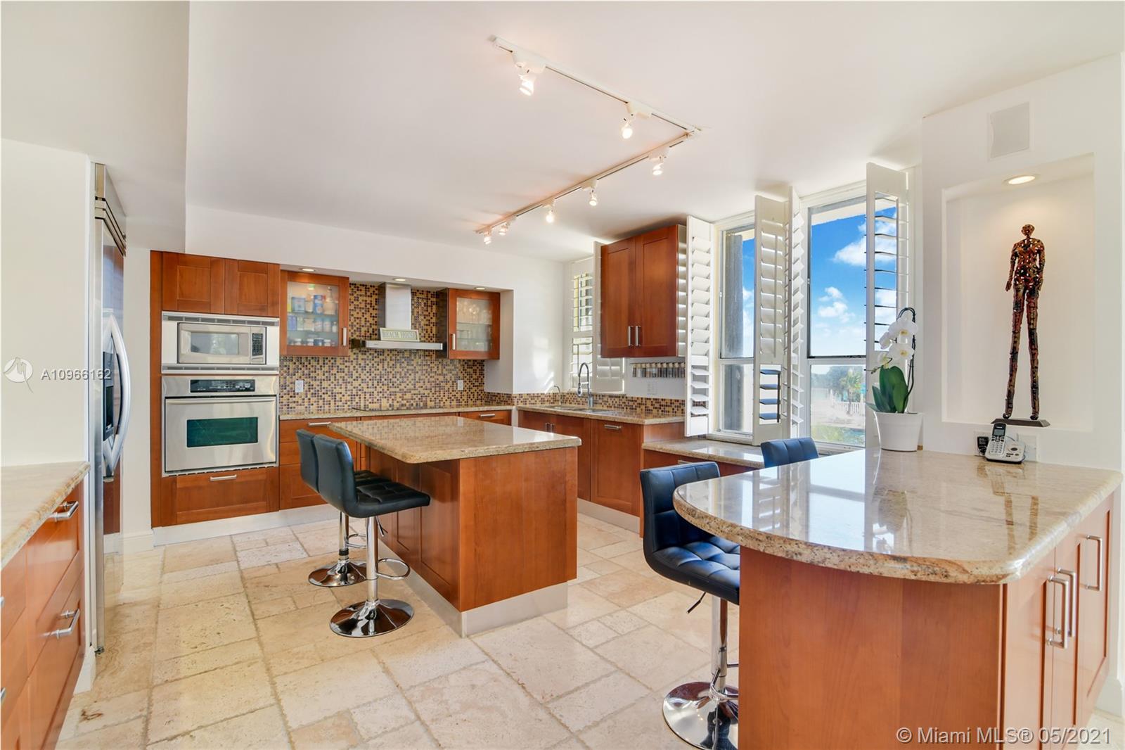 Photo of 9801 Collins Ave #4Z Direct Ocean, Bal Harbour, Florida, 33154 - Living room and kitchen looking the ocean and the pool