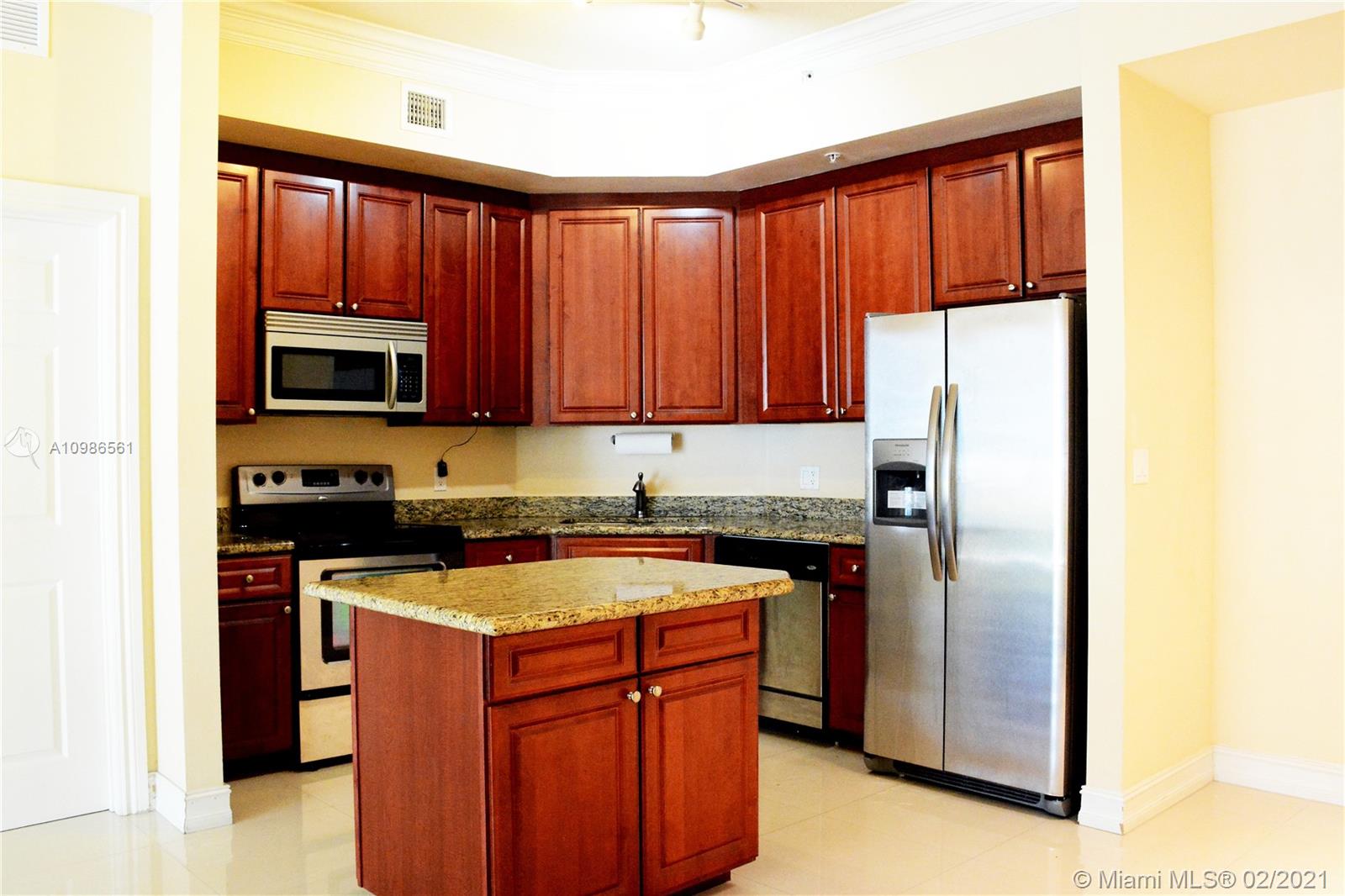 Photo of 3001 185th St #103, Aventura, Florida, 33180 - Kitchen, Living and Dining Areas and Entrance to Master Bedroom