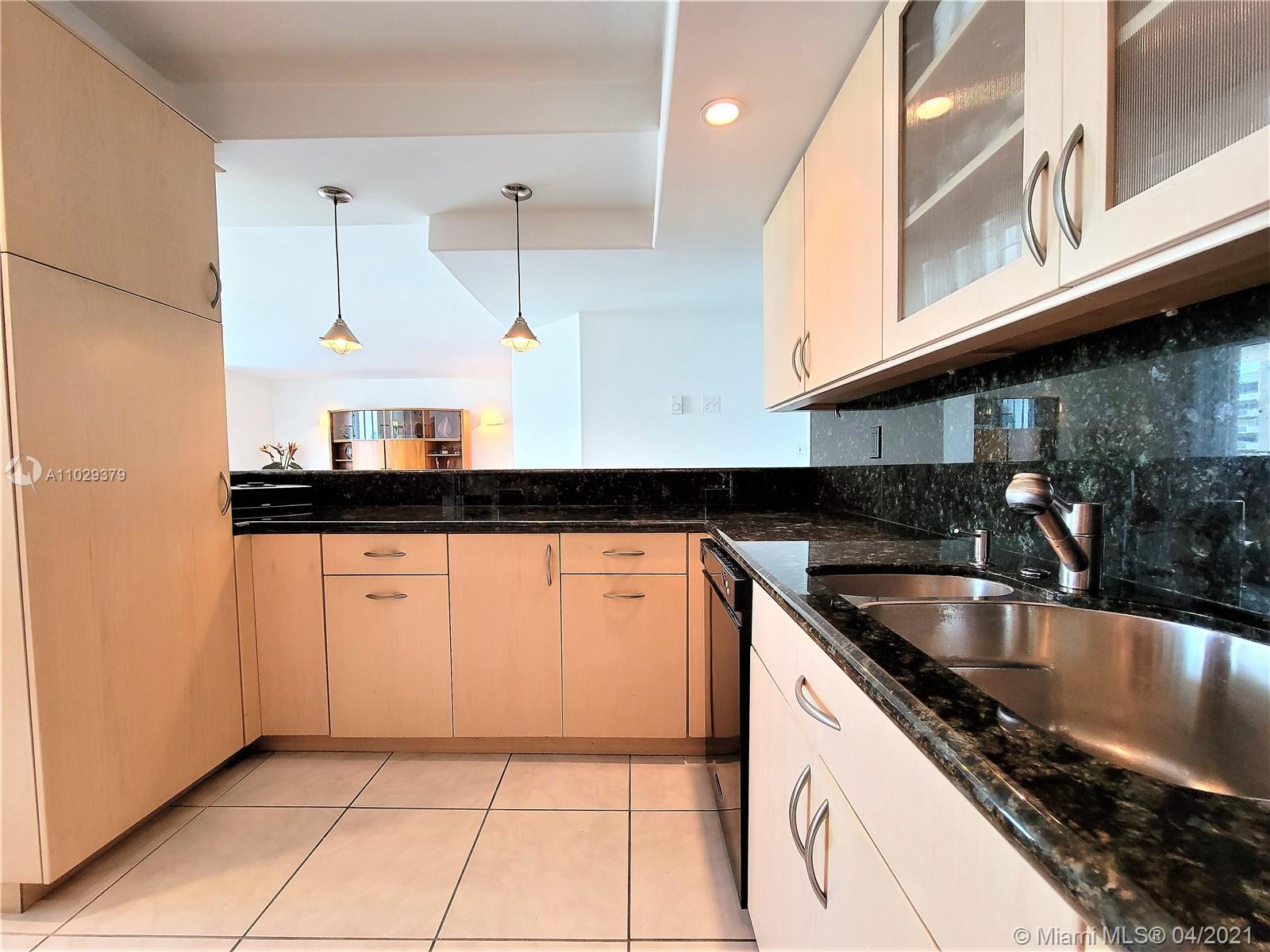 Photo of 2030 Ocean Dr #2026, Hallandale Beach, Florida, 33009 - Custom Kitchen, Gas Stove/Oven. Cabinetry Design Includes a Pantry with Pull Out Drawers, Also Special Cabinets That Maximize Storage Areas Making Hard to Reach Areas Functional & Easy To Use.