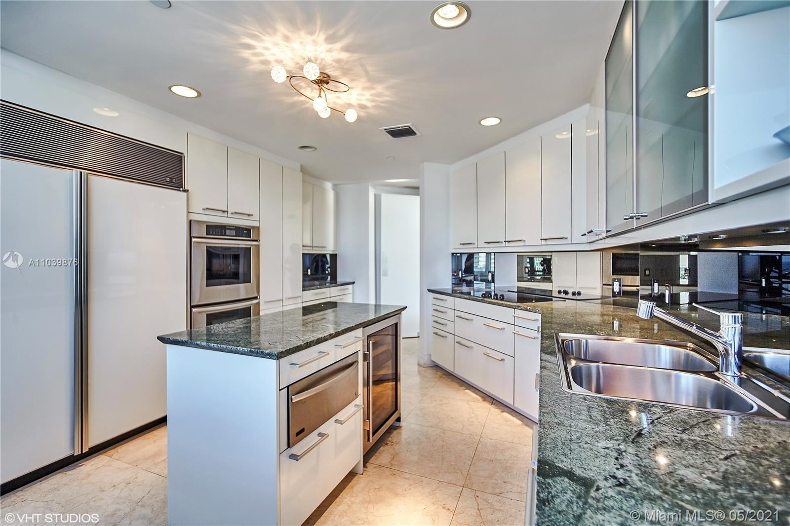Photo of 10225 Collins Ave #1703, Bal Harbour, Florida, 33154 - Large dine-in kitchen, fully stocked and equipped with refrigerator and freezer, double ovens, built-in microwave, dishwasher and wine refrigerator.