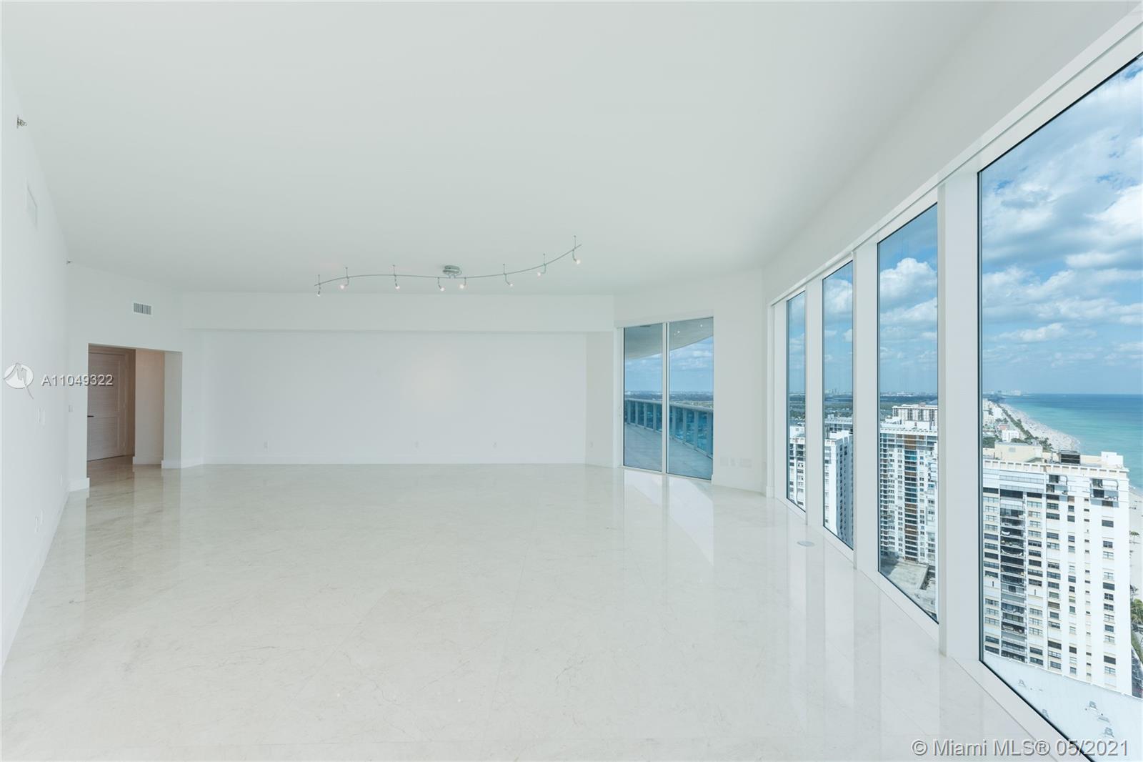Photo of 2711 Ocean Dr #3302, Hollywood, Florida, 33019 - LIVING ROOM OPEN TO DINING ROOM WITH BALCONY ACCESS