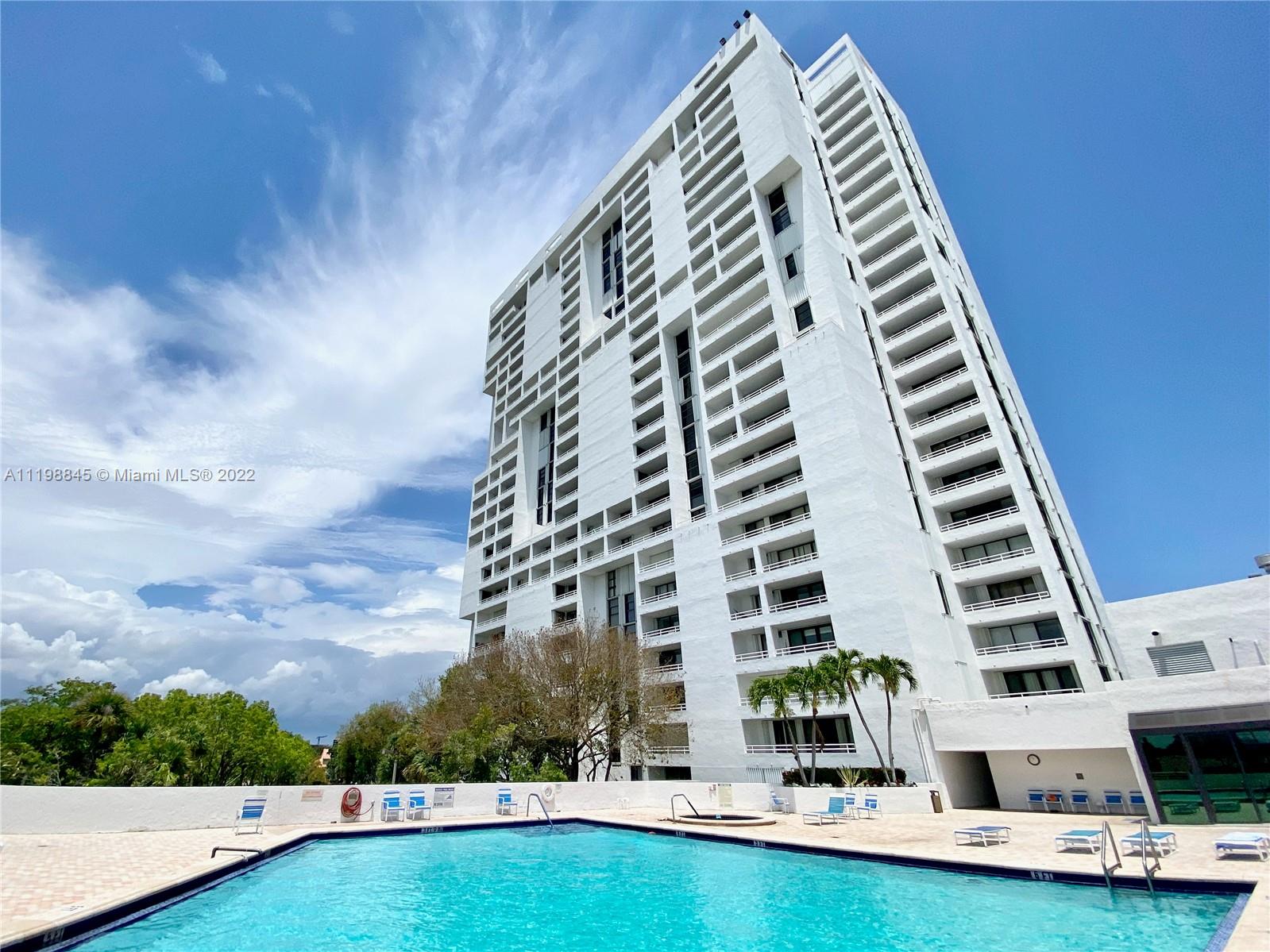 Stylish, modern living room with floor-to-ceiling windows and bright porcelain flooring.20355 NE 34th Ct., #826 - Delvista Condo.