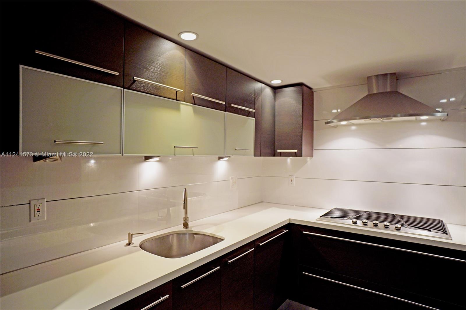 Photo of 2030 Ocean Dr #423, Hallandale Beach, Florida, 33009 - Living room with glass impact doors to balcony.