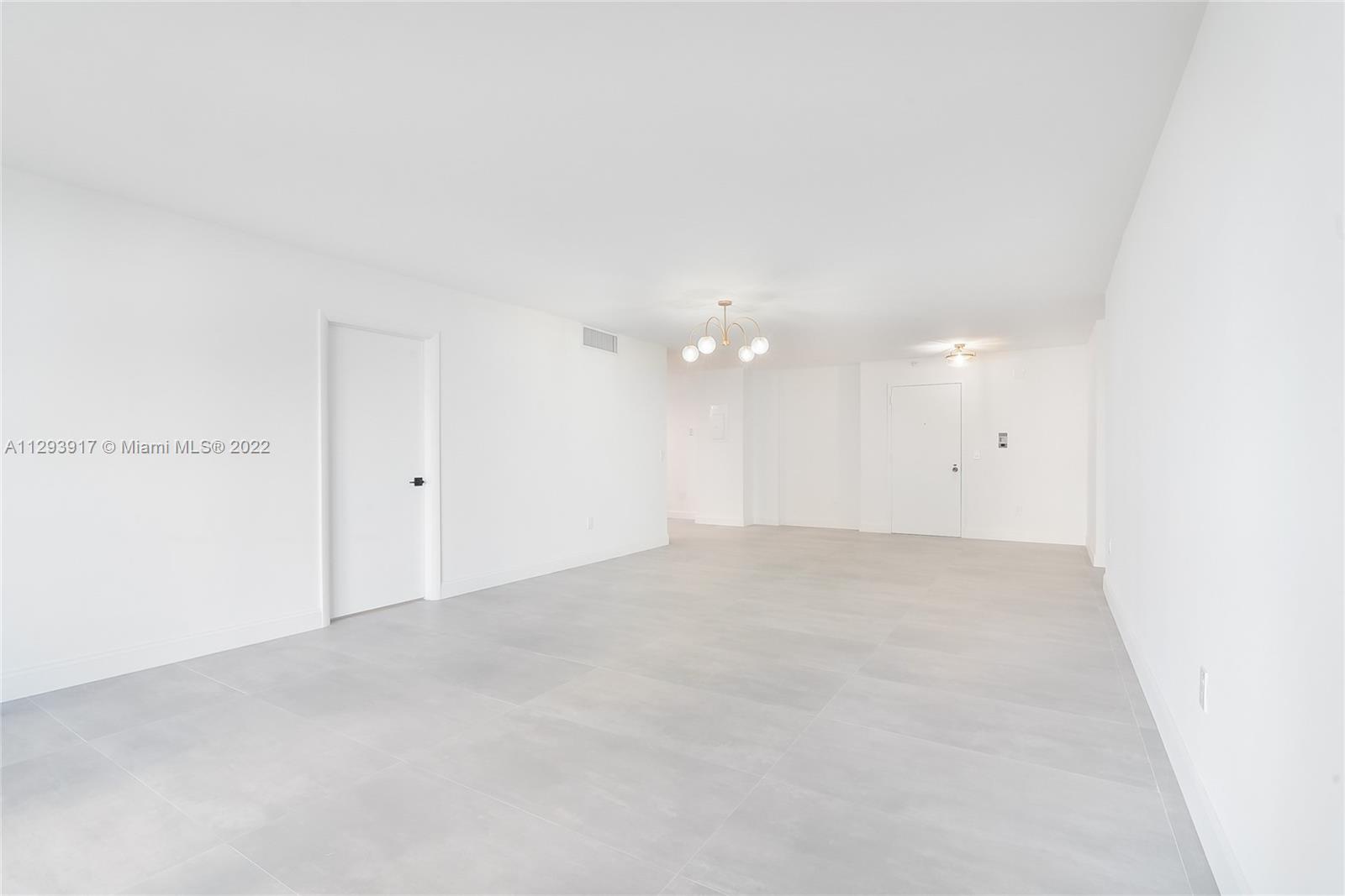 Photo of 9801 Collins Ave #6I, Bal Harbour, Florida, 33154 - Living room and sinning room. Photo showing the entrance door