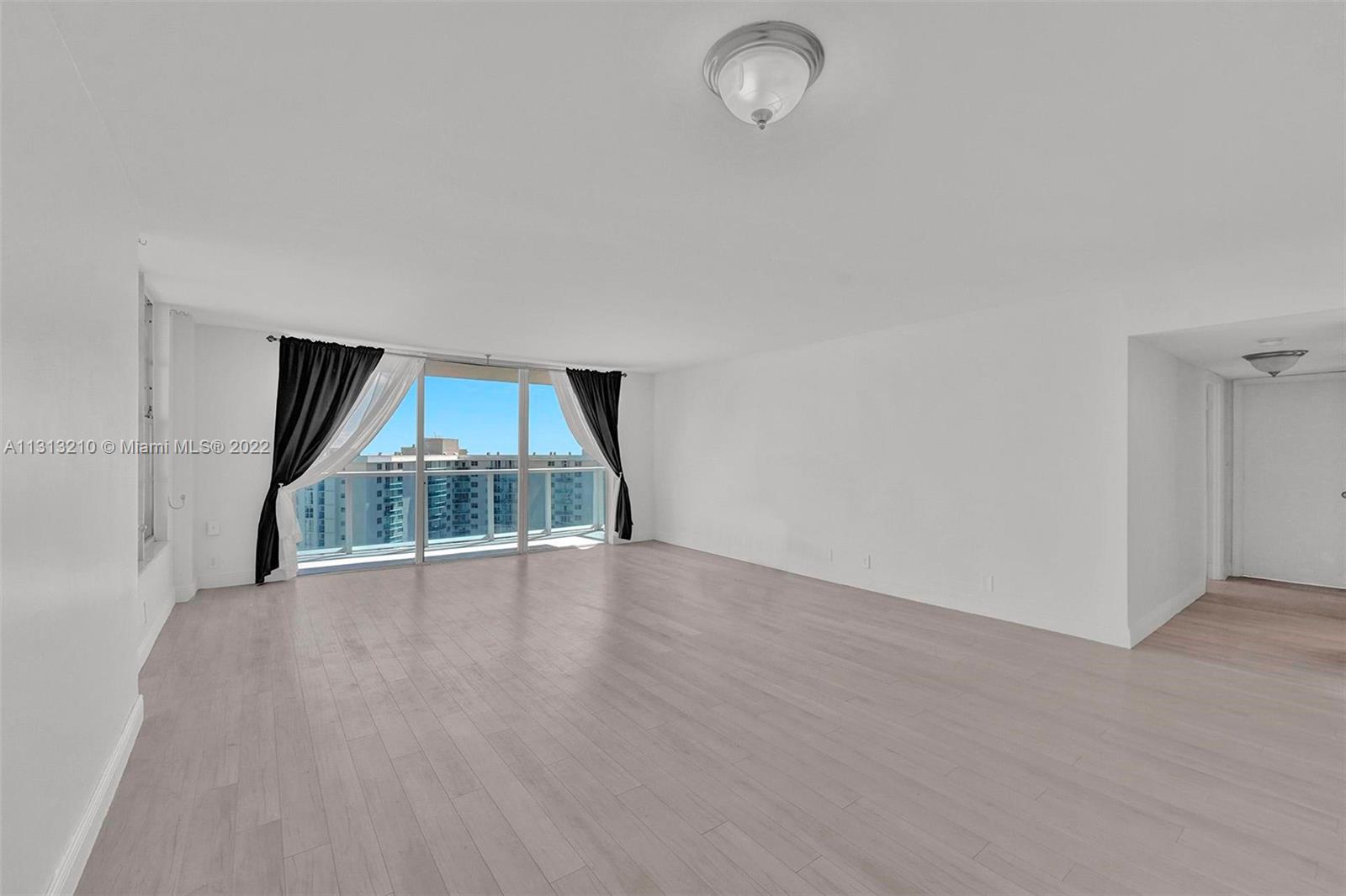 Photo of 3800 Ocean Dr #1720, Hollywood, Florida, 33019 - living room with balcony door