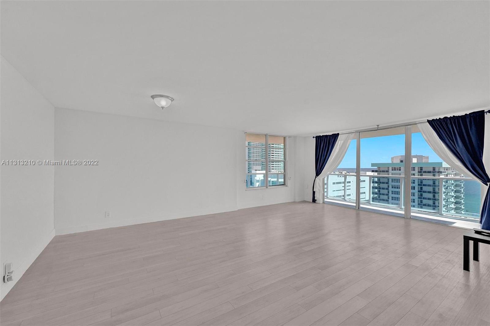 Photo of 3800 Ocean Dr #1720, Hollywood, Florida, 33019 - Enormous living room with corner balcony overlooking both the Ocean and the Intracoastal