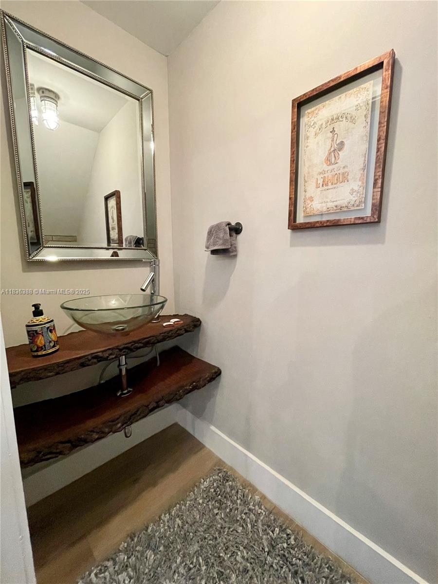 Photo of 1125 Papaya St  (1125), Hollywood, Florida, 33019 - Powder room, made with solid wood and elegant glass sink