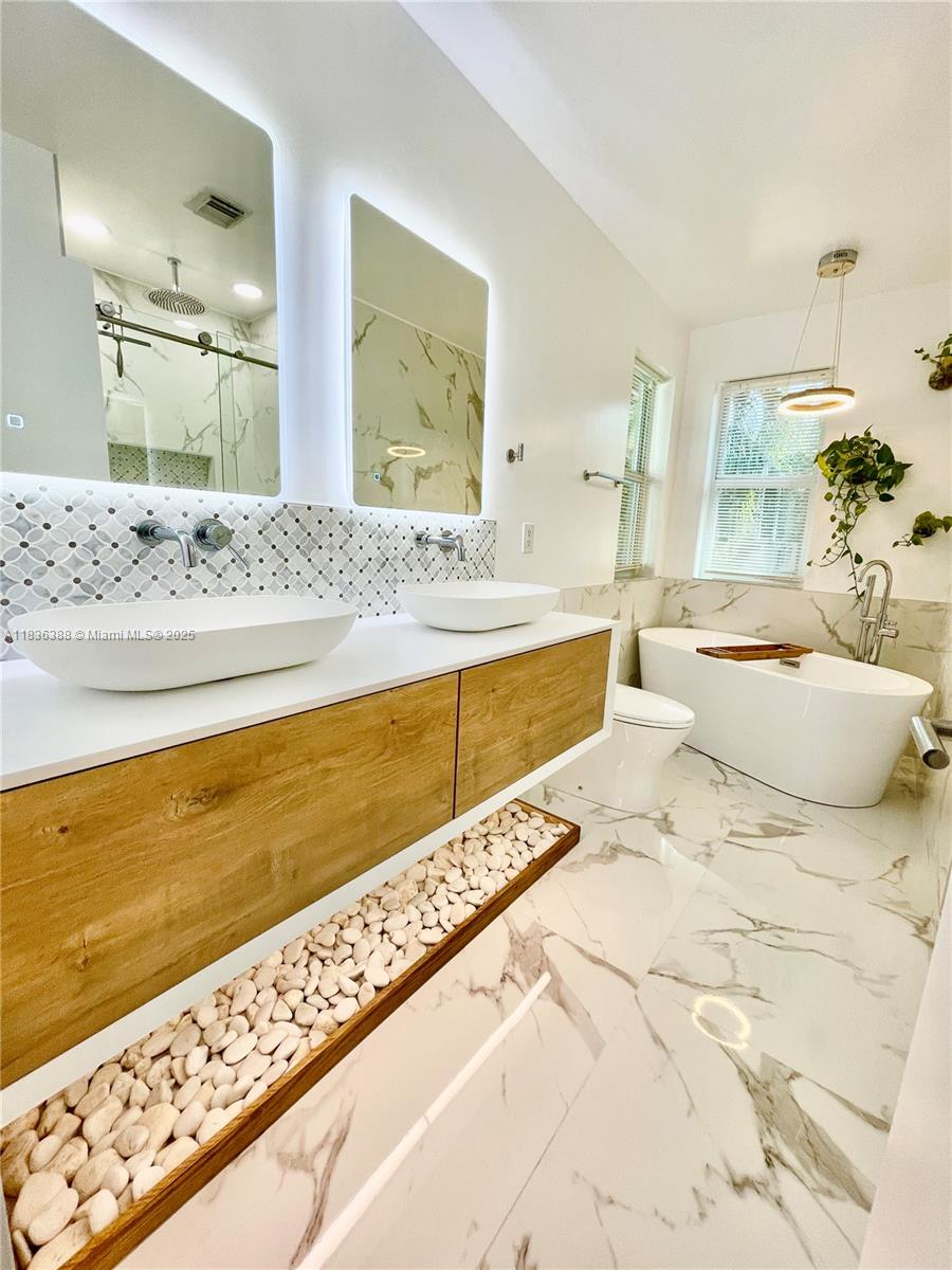 Photo of 1125 Papaya St  (1125), Hollywood, Florida, 33019 - Floating vanity with underweight and bluetooth mirrors with built in speakers