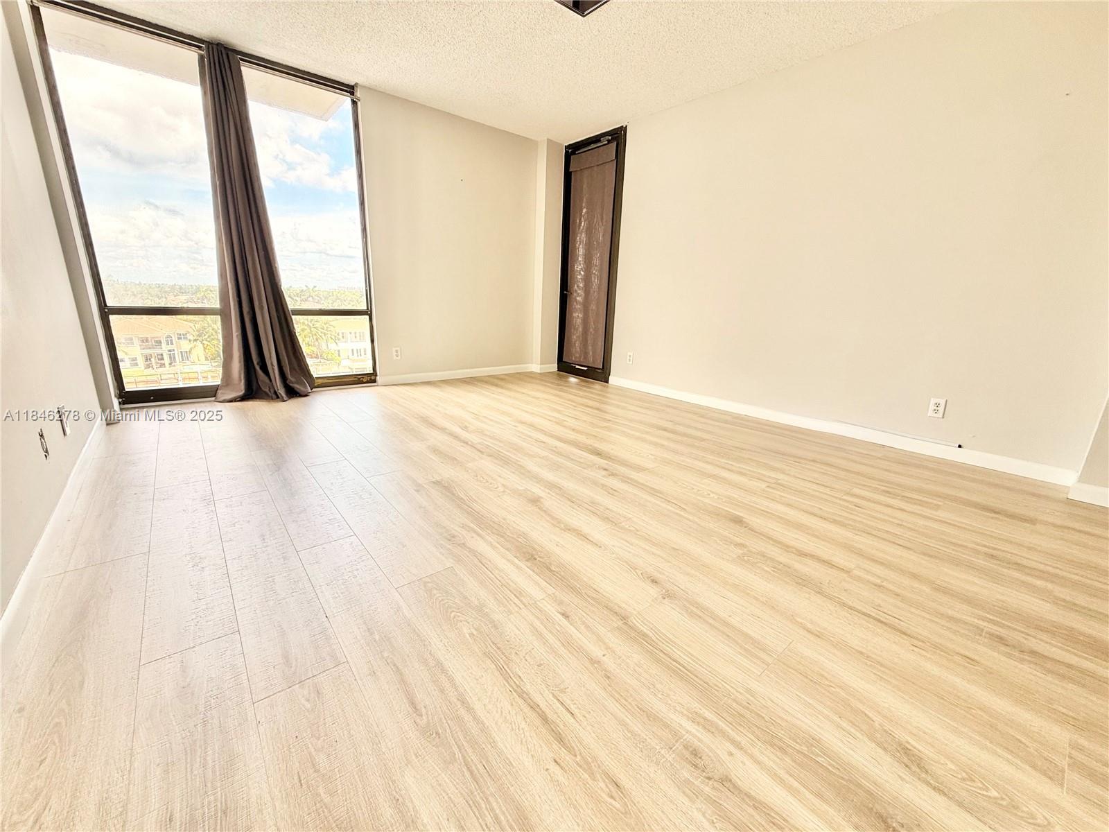 Photo of 1600 Ocean Dr  #7B, Hollywood, Florida, 33019 - Primary bedroom with entrance to balcony