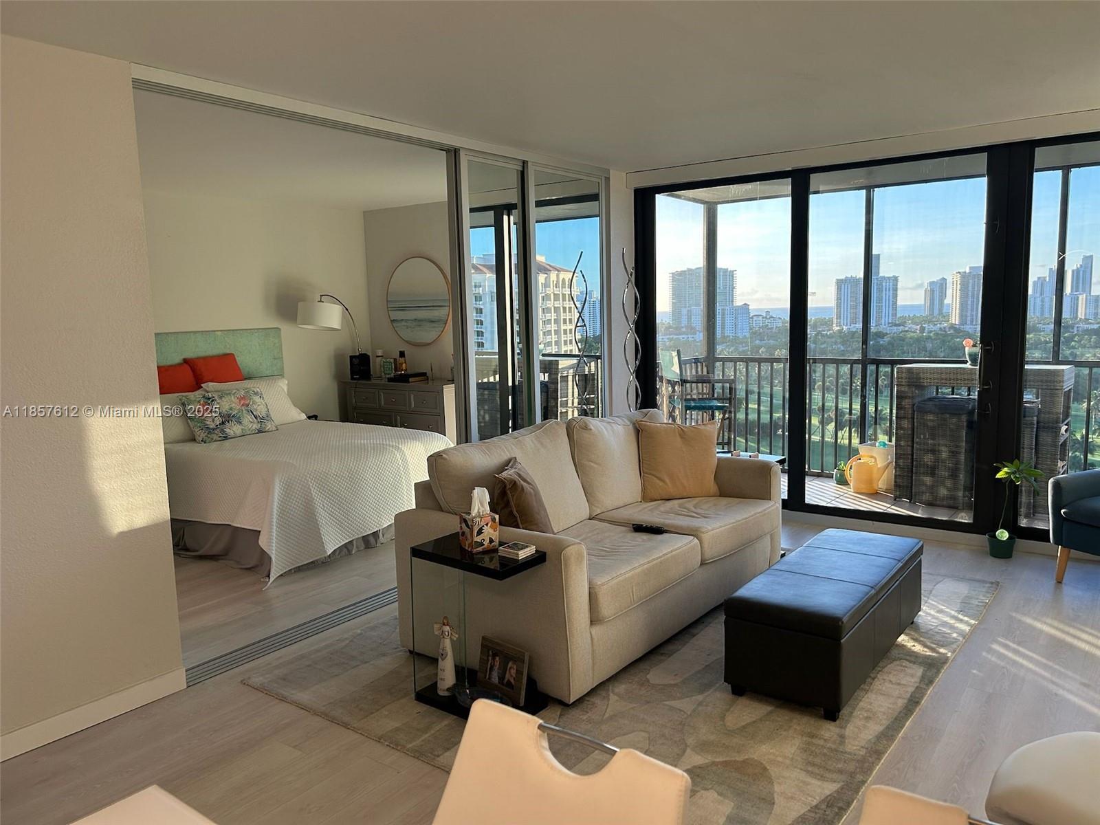 Photo of 20335 Country Club Dr  #1808, Aventura, Florida, 33180 - living room view with sliding mirror doors open to the second bedroom.