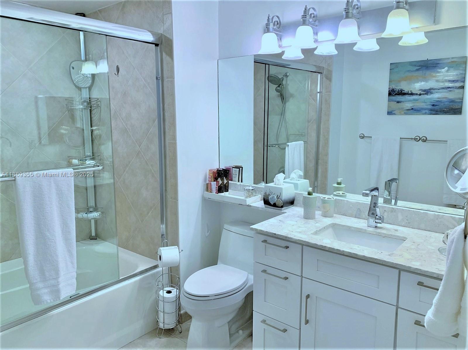 Photo of 2080 OCEAN DRIVE #PH3, Hallandale Beach, Florida, 33009 - Upgraded bathroom, new countertop, cabinetry and fixtures with glass shower door.