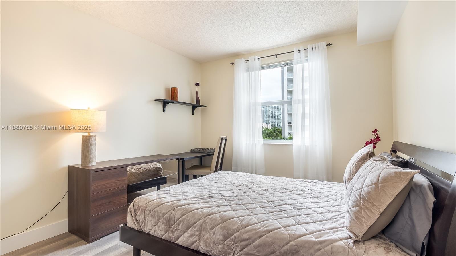 Photo of 17100 Bay Rd  #1603, Sunny Isles Beach, Florida, 33160 - Desk and Queen Bed