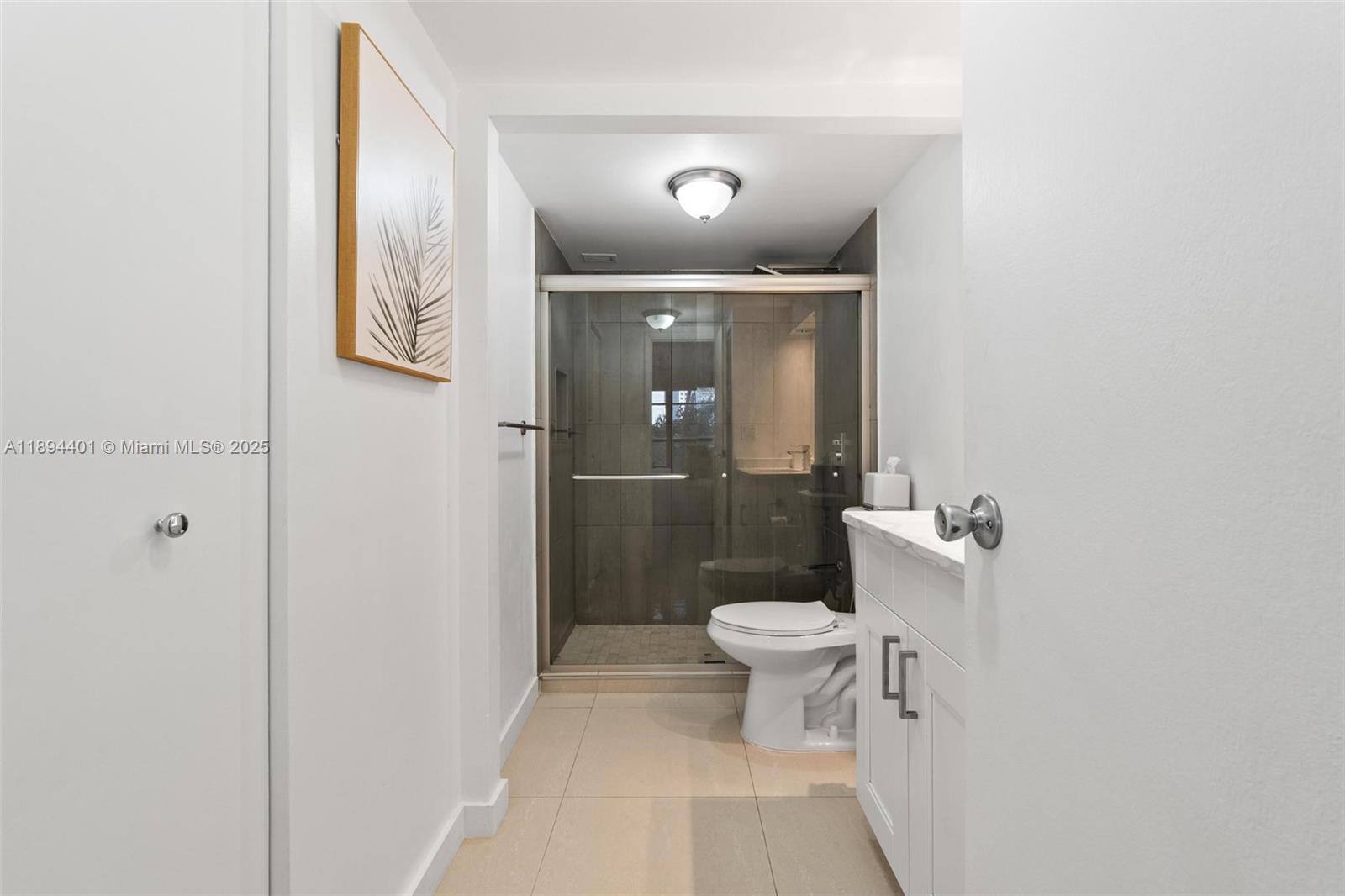 Photo of 600 Three Islands Blvd  #317, Hallandale Beach, Florida, 33009 - Master bath with walk-in shower and double linen / storage closets