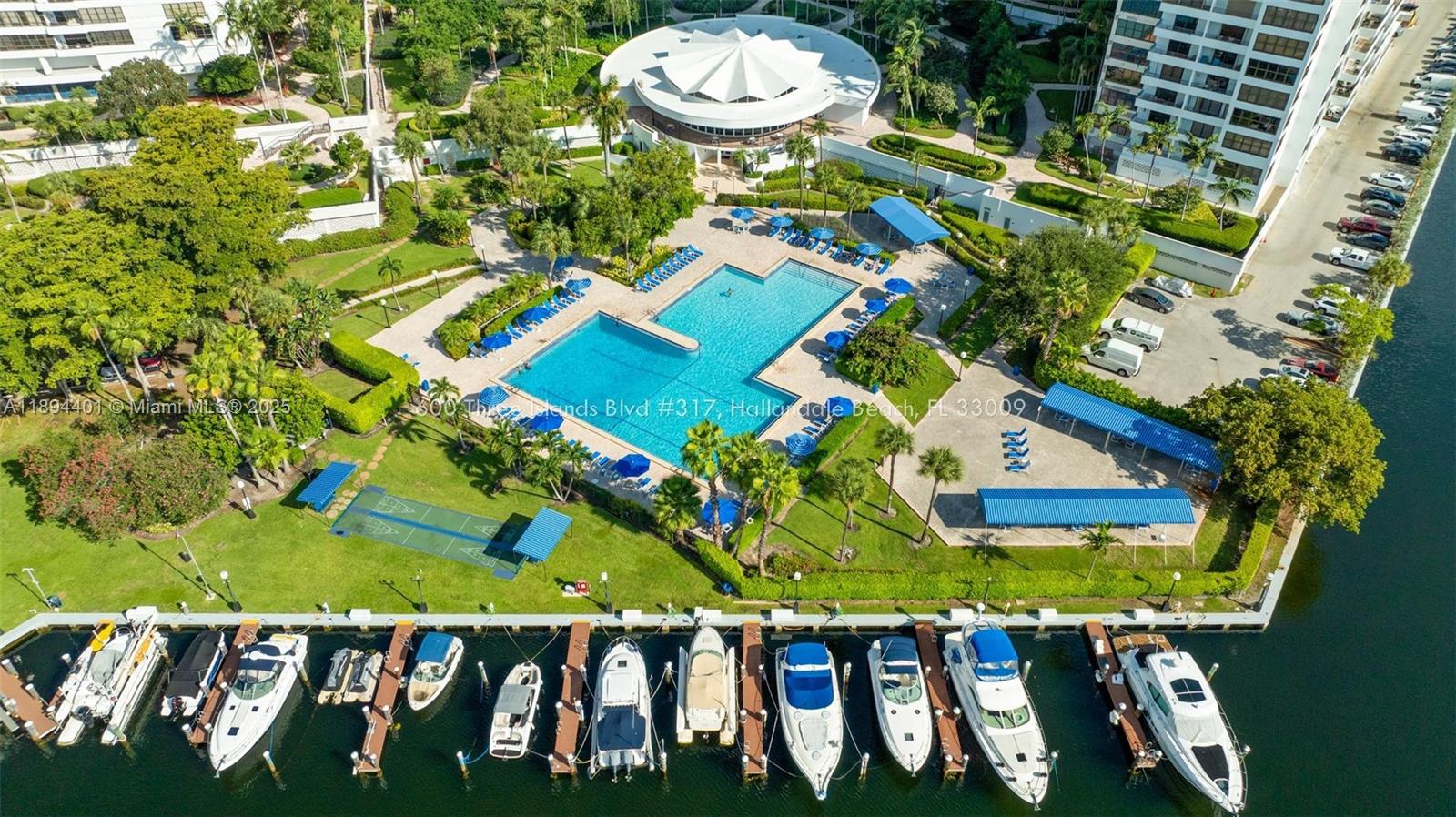 Photo of 600 Three Islands Blvd  #317, Hallandale Beach, Florida, 33009 - Overview of grounds, pool & marina