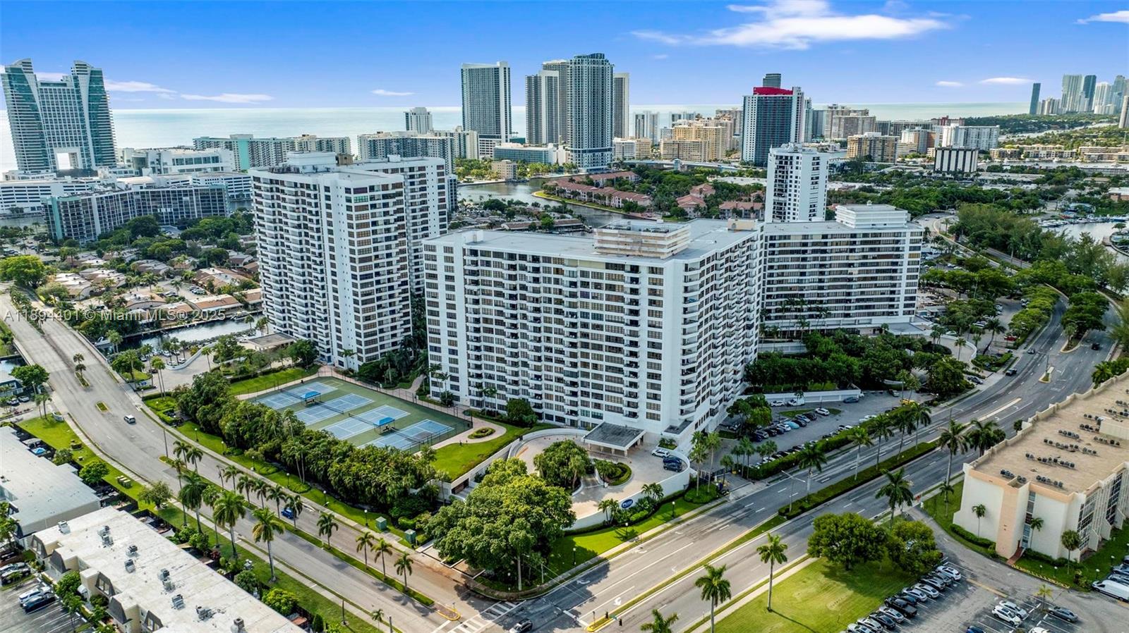 Photo of 600 Three Islands Blvd  #317, Hallandale Beach, Florida, 33009 - Overview of front entrance and sports courts