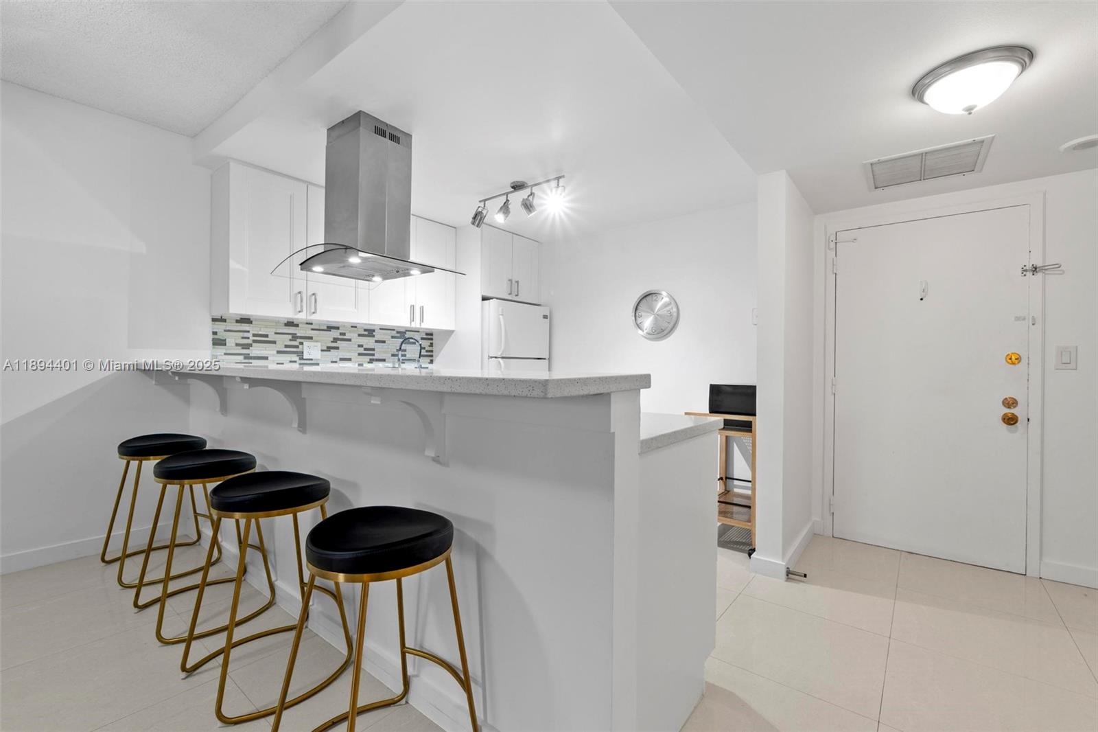 Photo of 600 Three Islands Blvd #317, Hallandale Beach, Florida, 33009 - Convenient breakfast bar for informal dining with undermount LED lighting