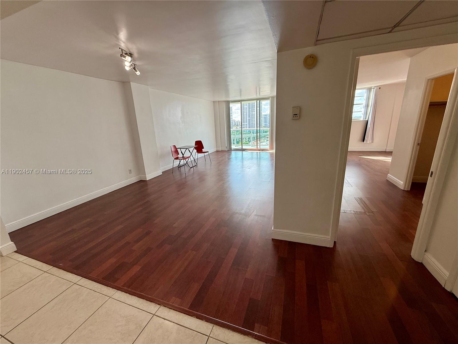 Photo of 19390 Collins Ave  #1423, Sunny Isles Beach, Florida, 33160 - View from Foyer to kitchen/living room on left, bedroom entrance on right