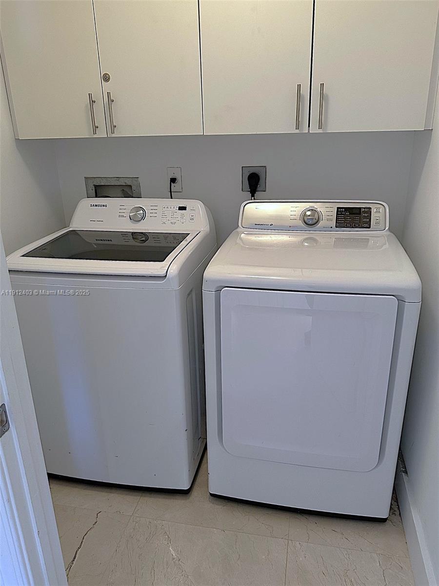 Photo of 2080 Ocean Dr #MPH12, Hallandale Beach, Florida, 33009 - Full size washer and dryer with cabinets