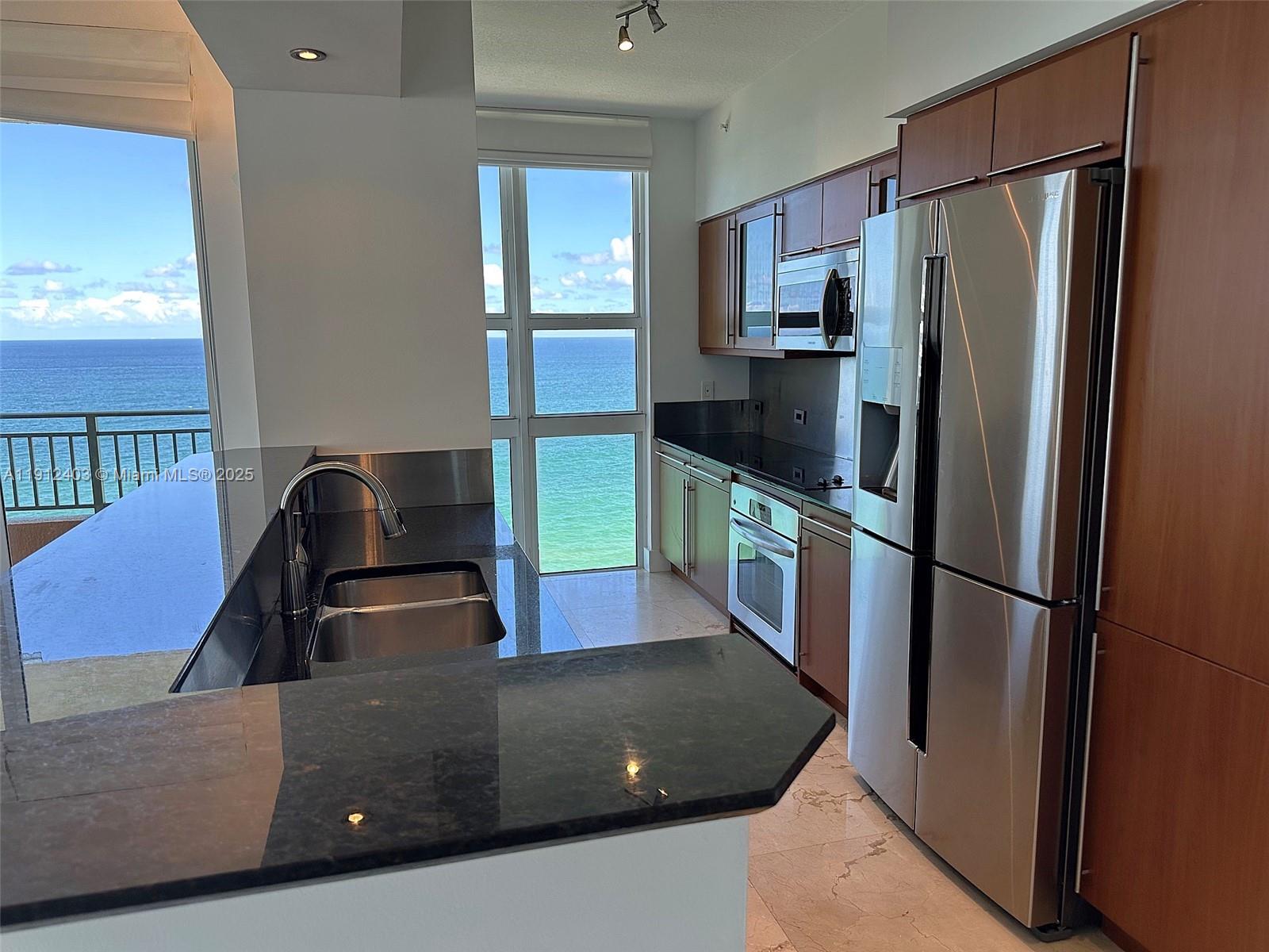 Photo of 2080 Ocean Dr #MPH12, Hallandale Beach, Florida, 33009 - Close-up of kitchen with stainless steel appliances, with a view