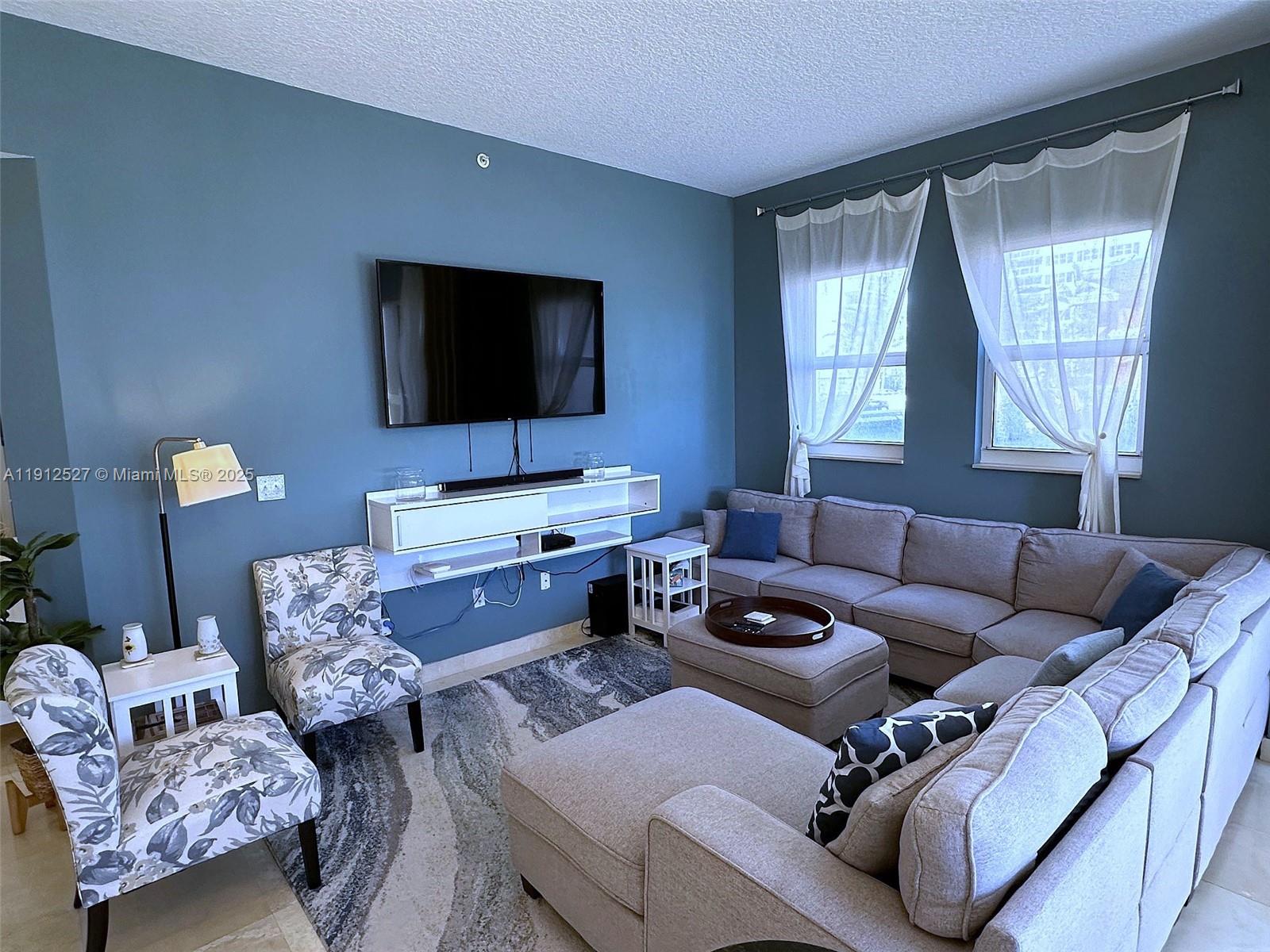 Photo of 2080 Ocean Dr #112, Hallandale Beach, Florida, 33009 - 10 ft tall ceilings, with large section couch