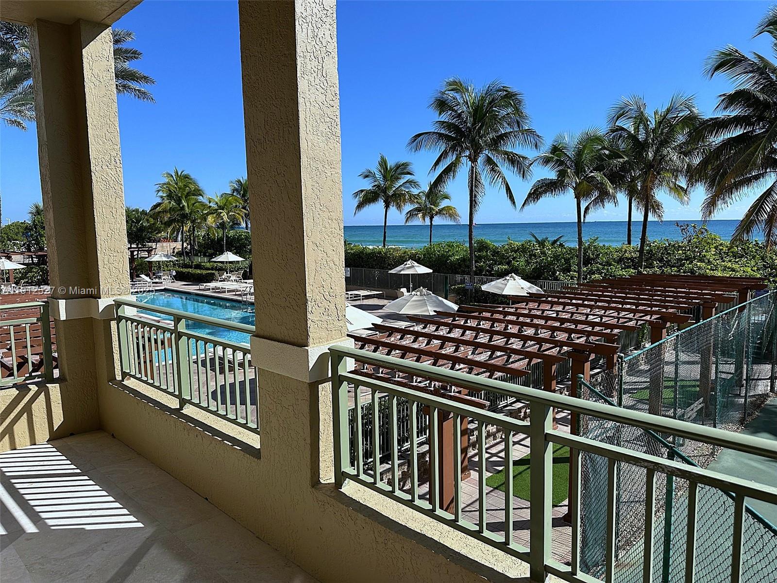 Photo of 2080 Ocean Dr #112, Hallandale Beach, Florida, 33009 - long balcony view of pool and ocean
