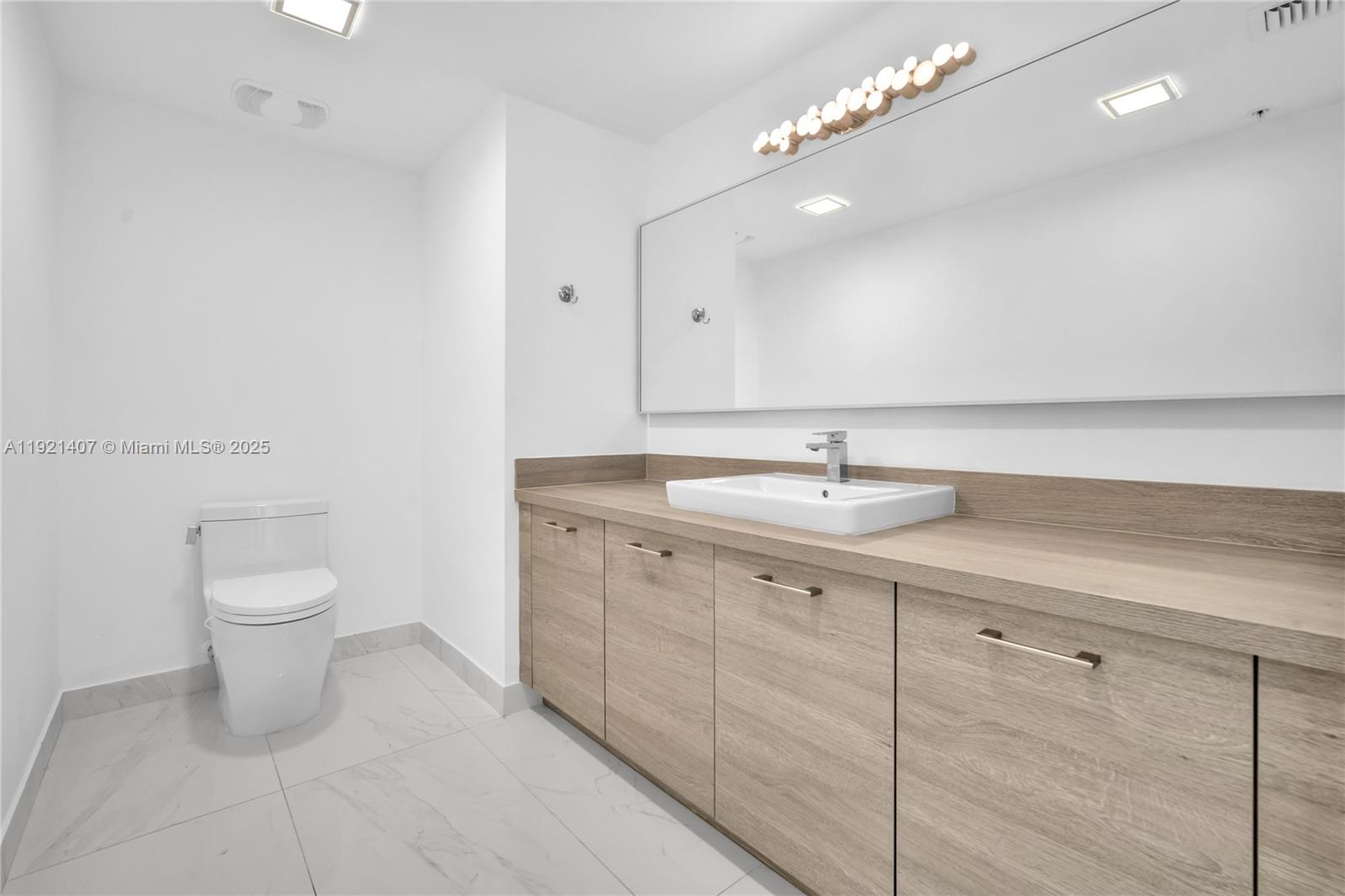 Photo of 400 Sunny Isles Blvd  #1519, Sunny Isles Beach, Florida, 33160 - Third 1/2 Bathroom next to the kitchen