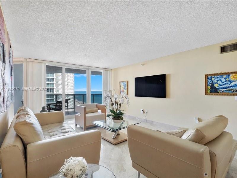 Photo of 16711 Collins Ave  #1604, Sunny Isles Beach, Florida, 33160 - Living room overlooking the ocean