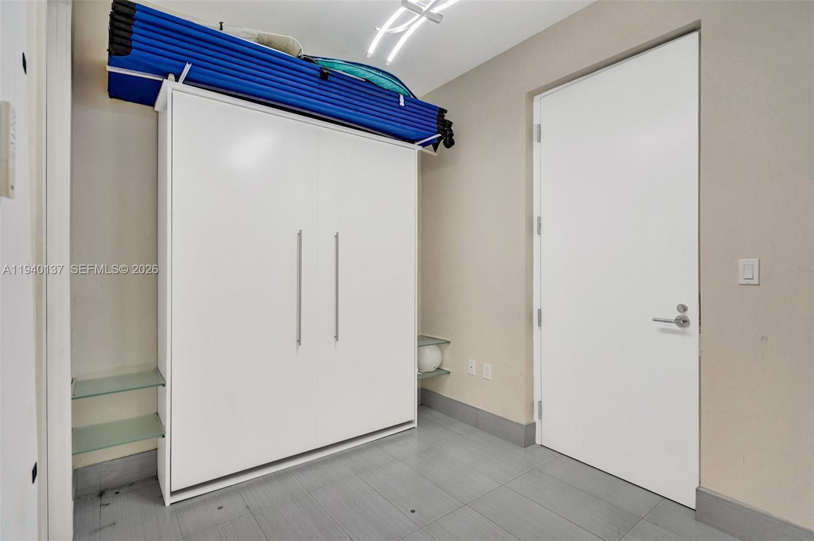 Photo of 17475 Collins Ave  #2502, Sunny Isles Beach, Florida, 33160 - Maids room which includes Murphy bed, Full bathroom, A wall of closets and service maintenance entrance