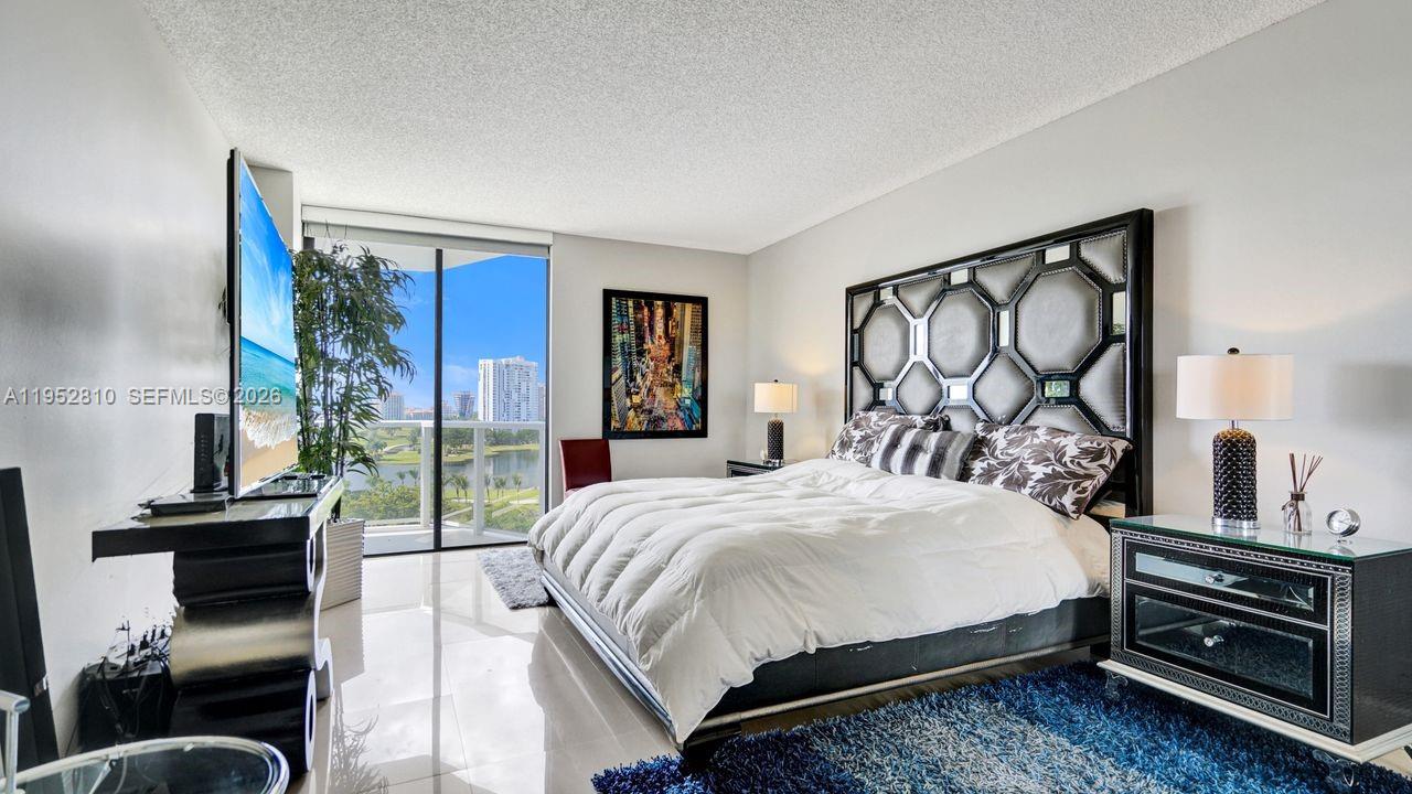 Photo of 20281 Country Club Dr  #809, Aventura, Florida, 33180 - Master bedroom with direct lake views.