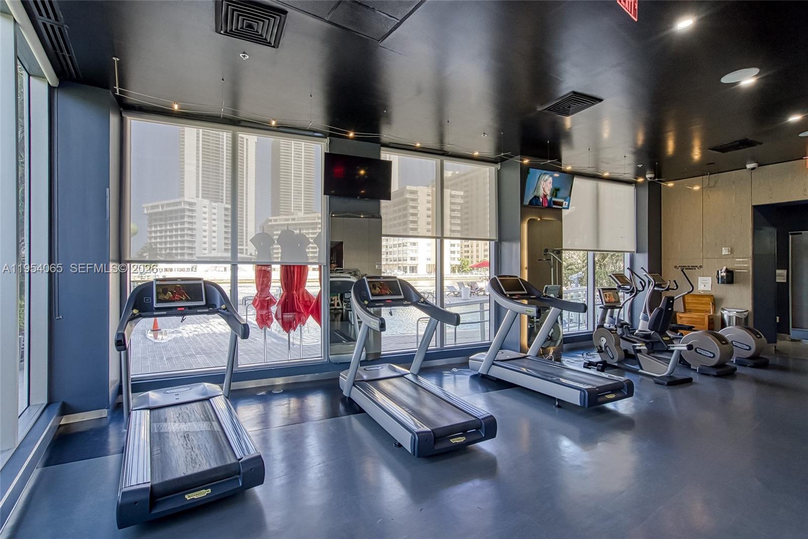 Photo of 2602 Hallandale Beach Blvd  #R2304, Hallandale Beach, Florida, 33009 - Full size gym with a pool and intracoastal view.