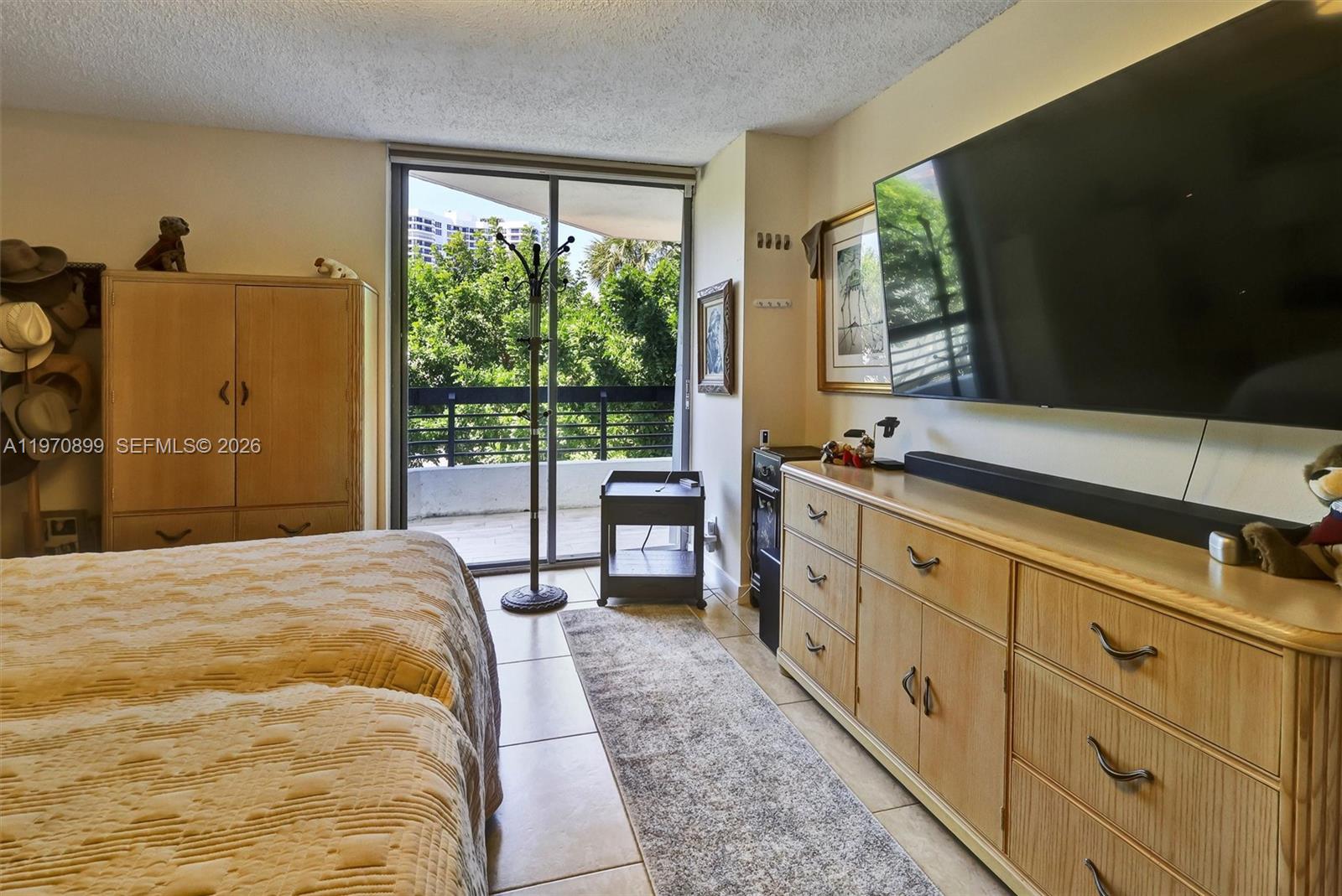 Photo of 3500 Mystic Pointe Dr  #302, Aventura, Florida, 33180 - Generously sized retreat with a large walk-in closet and sleek electric blinds for added comfort and privacy.