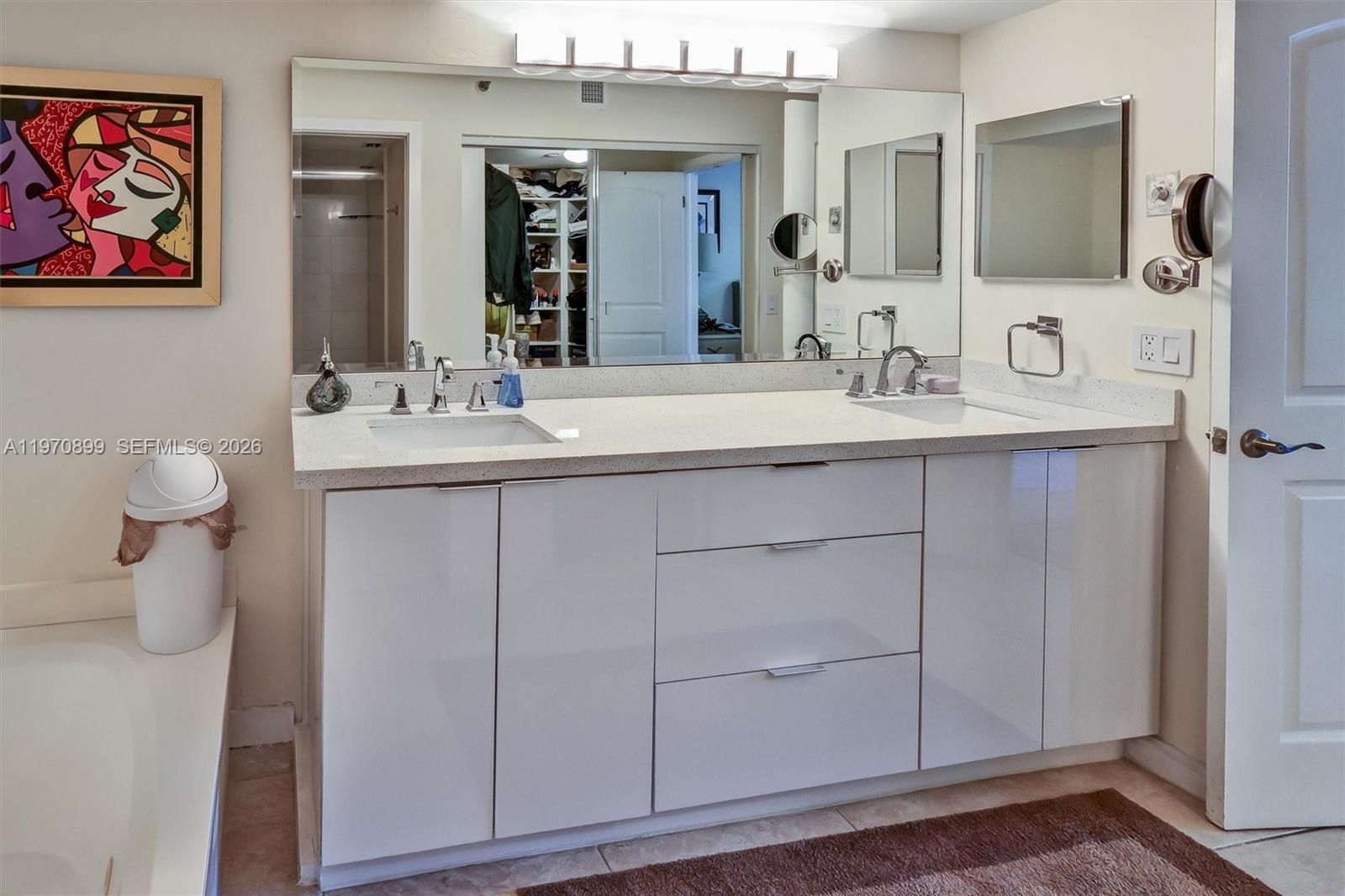 Photo of 3500 Mystic Pointe Dr  #302, Aventura, Florida, 33180 - Spa-inspired layout featuring a separate glass-enclosed shower and a relaxing jet tub.