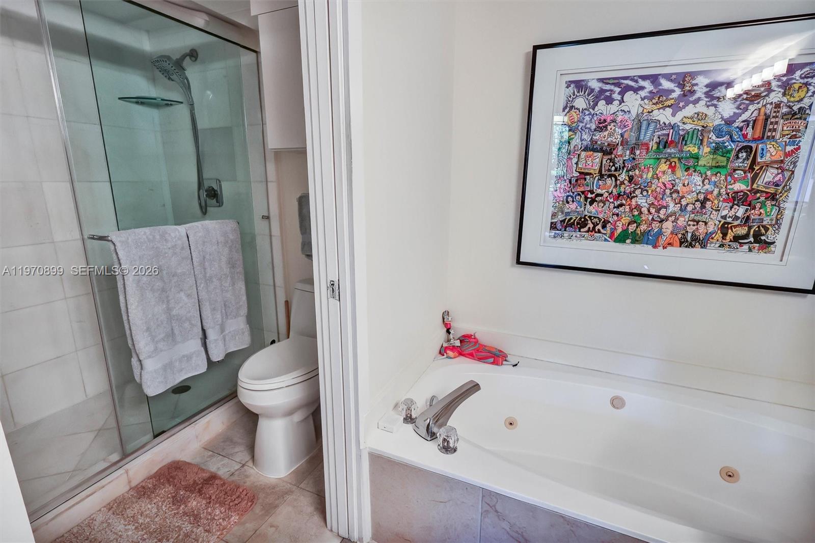 Photo of 3500 Mystic Pointe Dr  #302, Aventura, Florida, 33180 - Spa-inspired layout featuring a separate glass-enclosed shower and a relaxing jet tub.