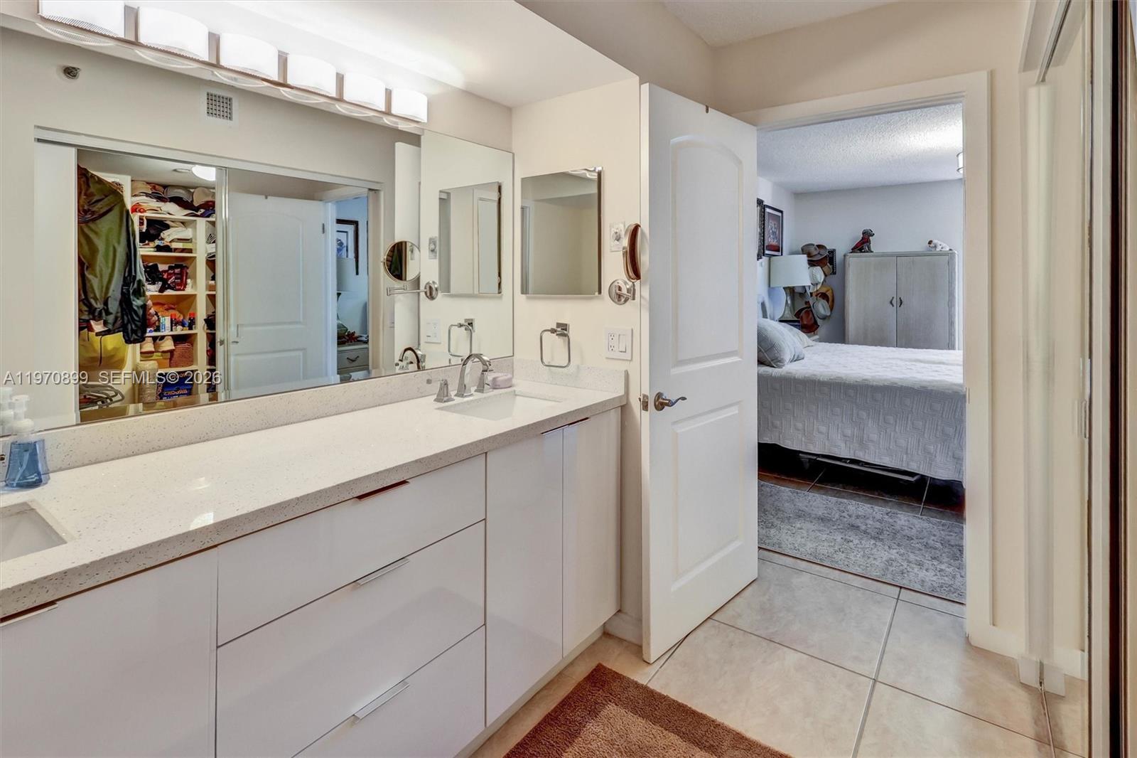 Photo of 3500 Mystic Pointe Dr  #302, Aventura, Florida, 33180 - Spa-inspired layout featuring a separate glass-enclosed shower and a relaxing jet tub.