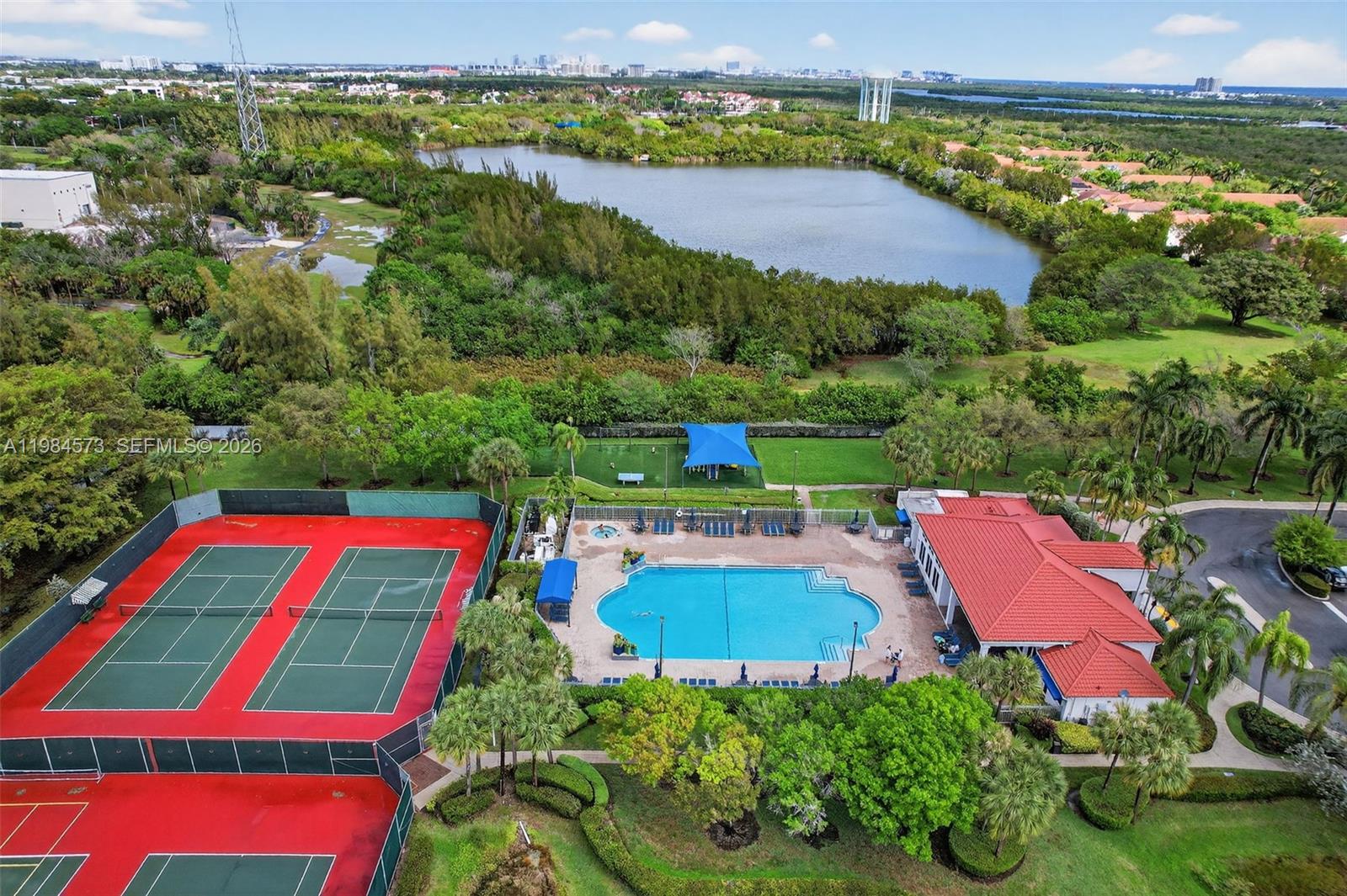 Photo of 1860 Sweetbay Way  (1860), Hollywood, Florida, 33019 - Community pool, clubhouse, children's playground, and tennis courts