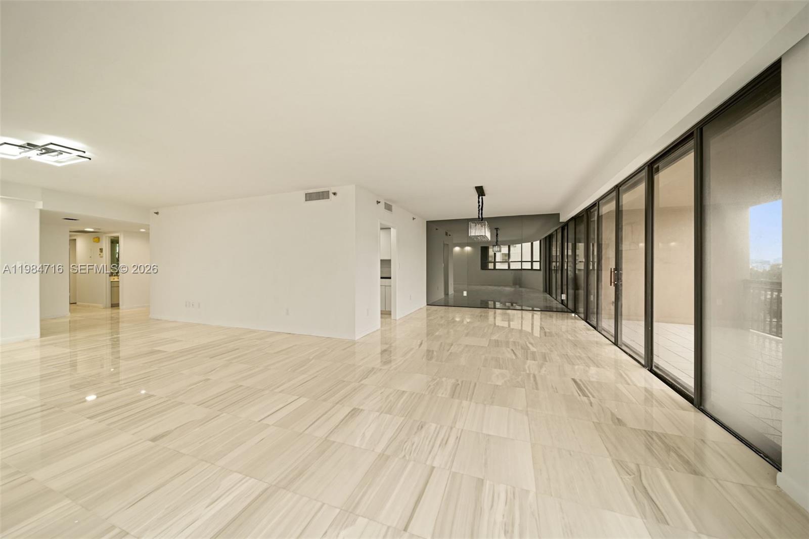 Photo of 10175 Collins Ave  #807, Bal Harbour, Florida, 33154 - L Shaped Living and Dining Room overlooking Biscayne Bay