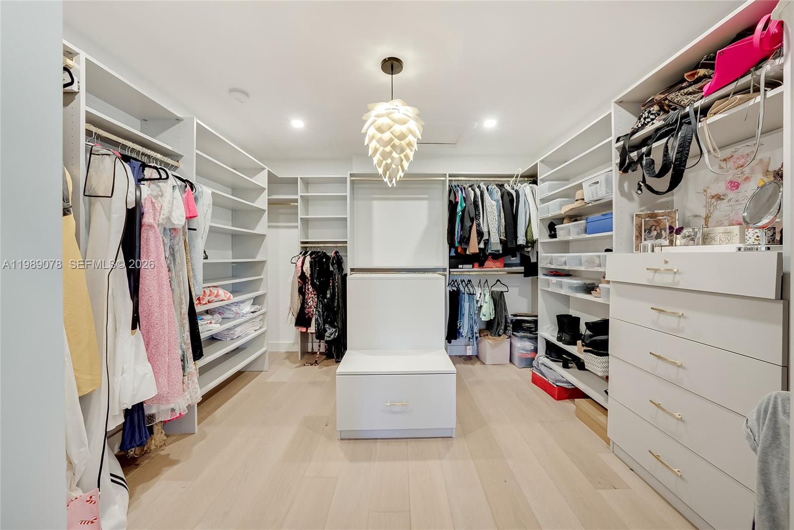 Photo of 20765 32nd Ave  (20765), Aventura, Florida, 33180 - Boutique like closet in primary bedroom offers space for an island or seating for a luxurious dressing area