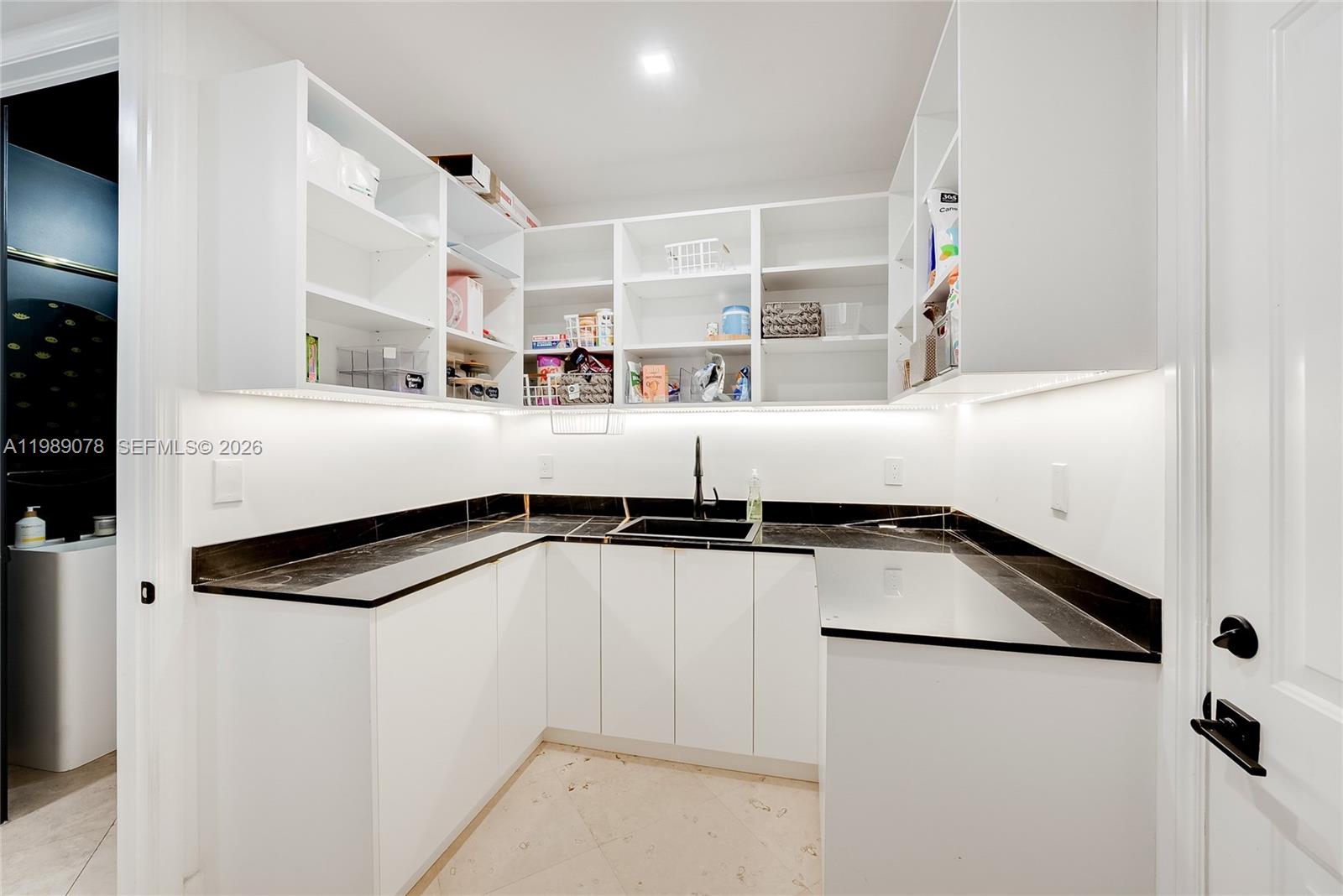 Photo of 20765 32nd Ave  (20765), Aventura, Florida, 33180 - Butler's pantry off two car garage makes for great storage for your large family and easy access to car and home