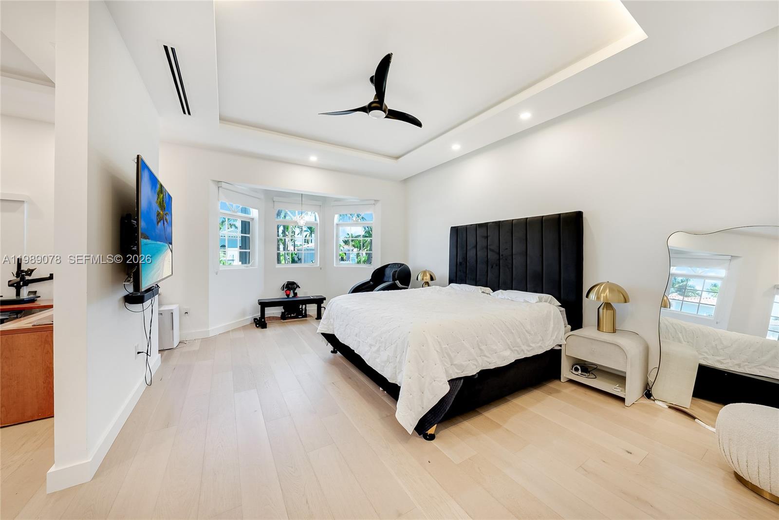 Photo of 20765 32nd Ave  (20765), Aventura, Florida, 33180 - Open and luxurious primary bedroom with creative office/dressing area