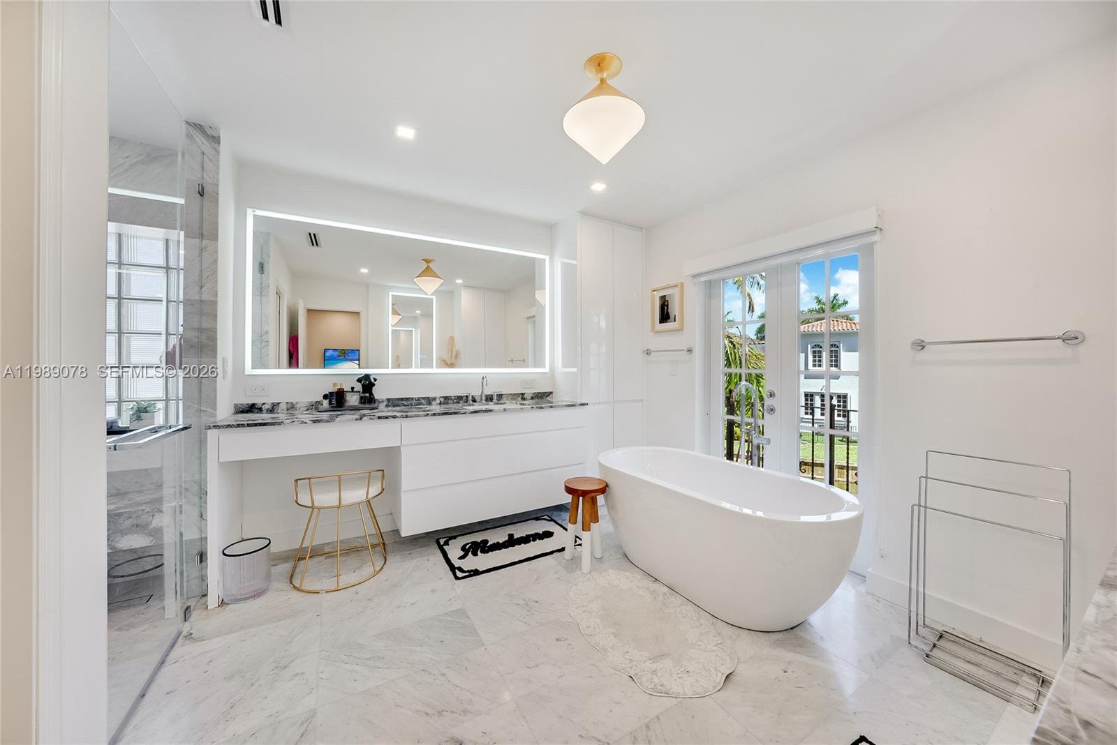 Photo of 20765 32nd Ave  (20765), Aventura, Florida, 33180 - Updated, modern spa like primary bath with marble touches and premium fixtures