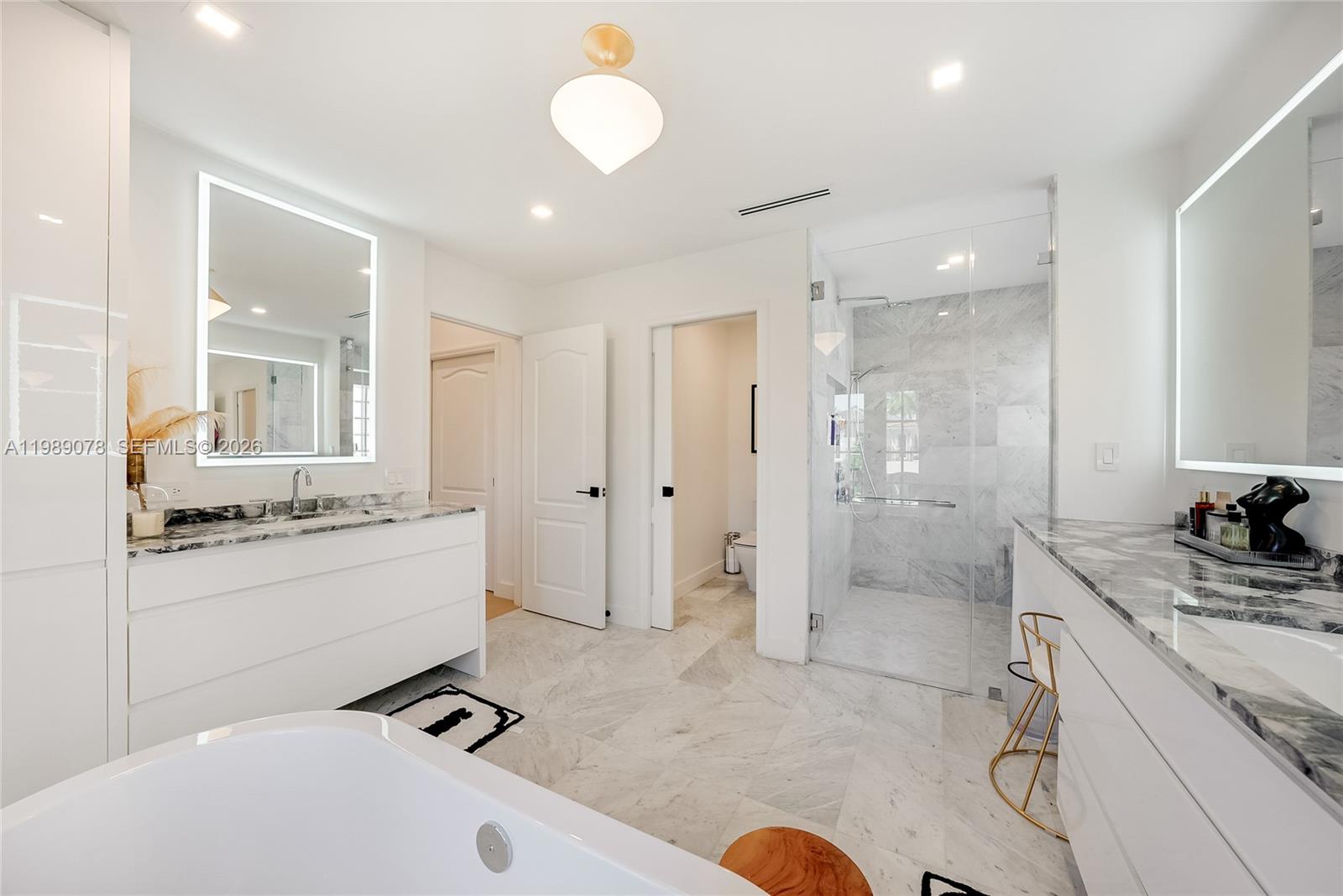 Photo of 20765 32nd Ave  (20765), Aventura, Florida, 33180 - Primary spa like bath offers marble, expansive walk in shower, double vanity and separate bathtub